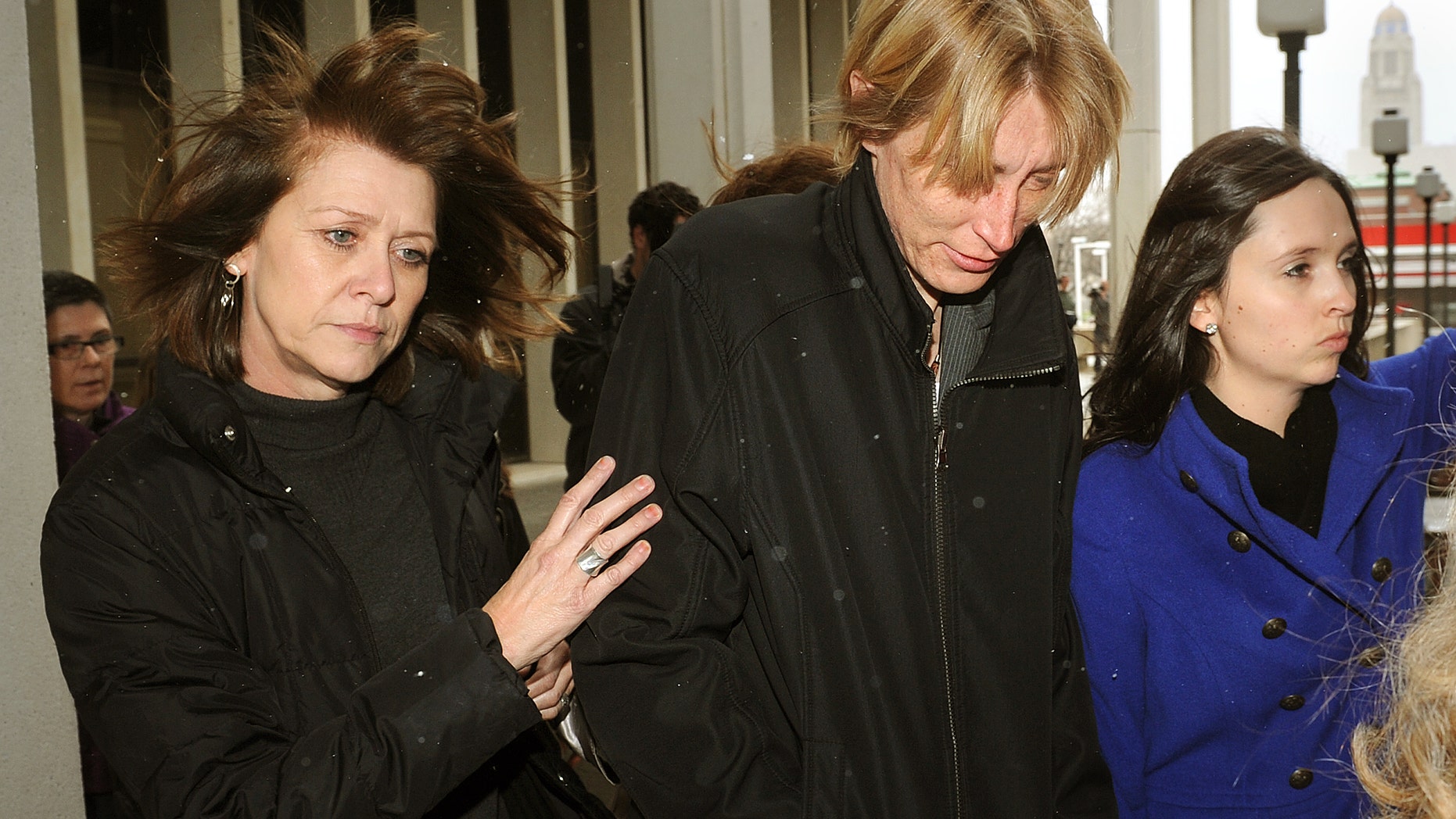Charlie Rogers, center, is escorted by supporters from the Lancaster County Court Justice and Law Enforcement Center on Thursday, April 18, 2013, in Lincoln, Neb. Rogers was sentenced to a week in jail and two years of probation for falsely claiming she had been attacked by three men who carved anti-gay slurs into her body. (AP Photo/The Journal-Star, Eric Gregory) LOCAL TV OUT; KOLN-TV OUT; KGIN-TV OUT; KLKN-TV OUT