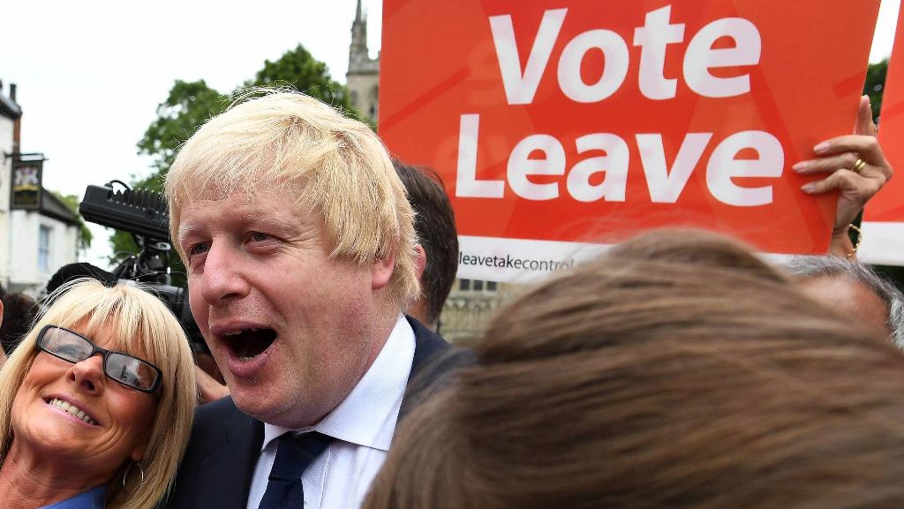 FILE In this Wednesday, June 22, 2016 file photo, advocate to exit Europe Boris Johnson poses for a selfie photo with voters during a whistle stop tour of the country on the final day of campaigning before Thursday's EU referendum vote, in Selby, north England. (Andrew Parsons / PA via AP, File) UNITED KINGDOM OUT - NO SALES - NO ARCHIVES