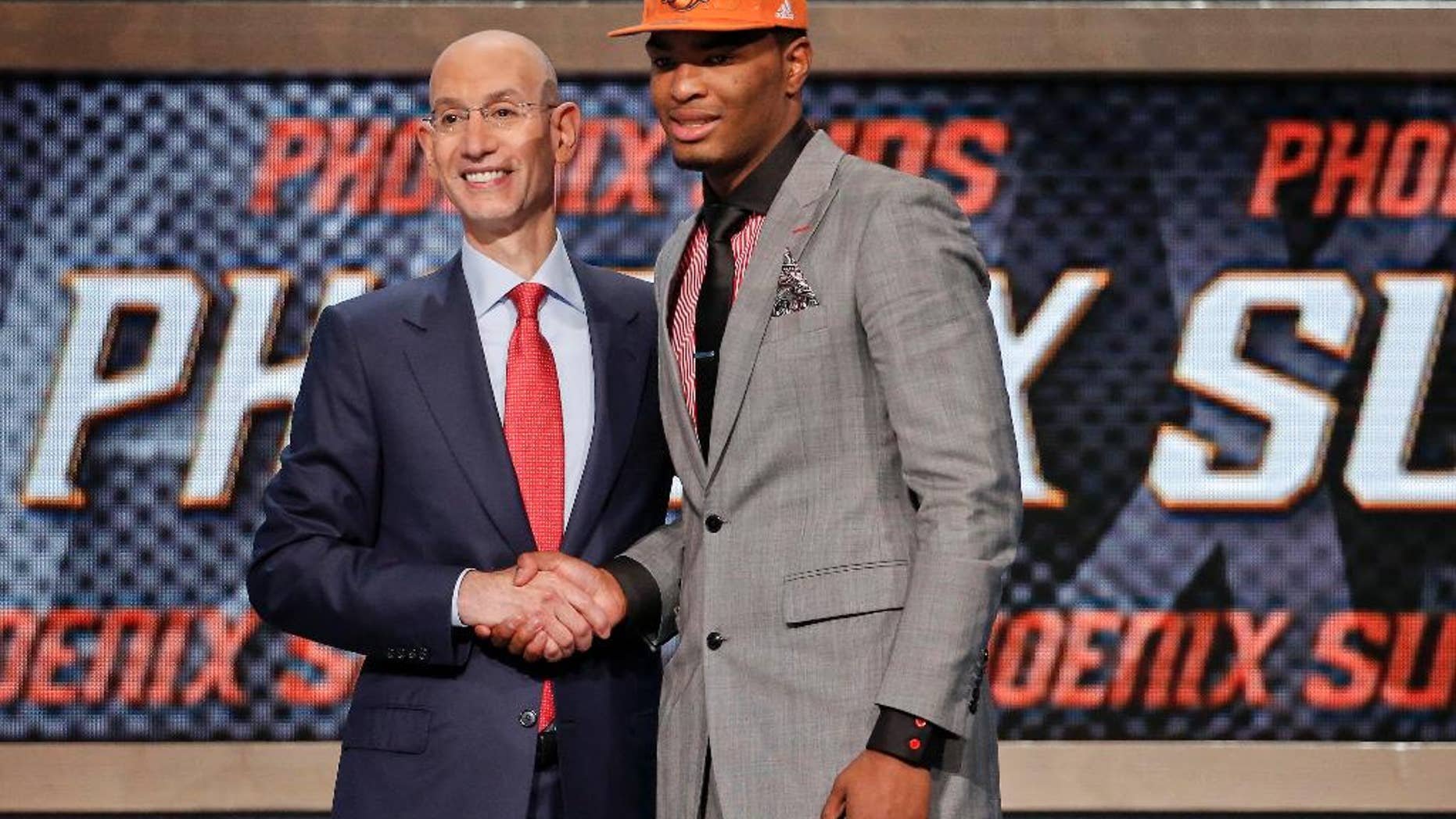 North Carolina State's T.J. Warren, right, poses for a photo with NBA Commissioner Adam Silver after being selected 14th overall by the Phoenix Suns during the 2014 NBA draft, Thursday, June 26, 2014, in New York. (AP Photo/Jason DeCrow)