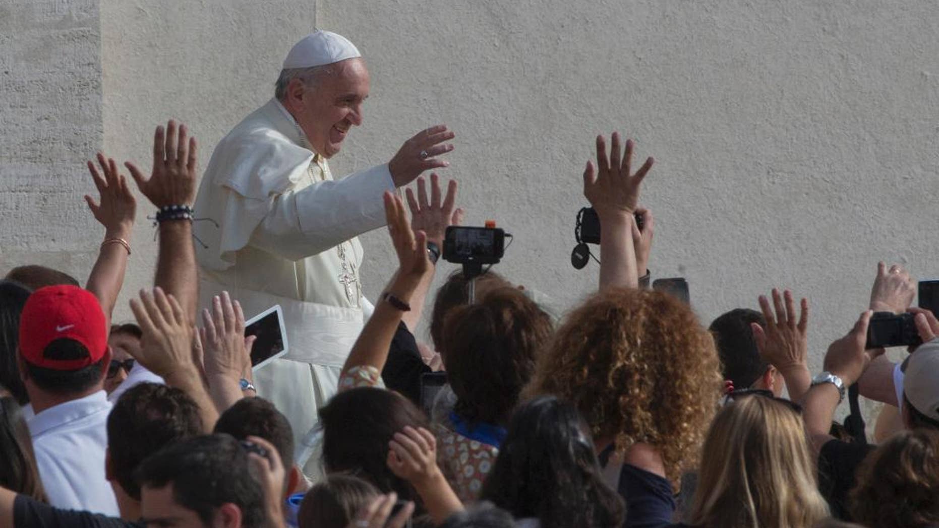 Pope Francis waves as he arrives for his weekly general audience in St. Peter's Square at the Vatican, Wednesday, Sept. 9, 2015. (AP Photo/Alessandra Tarantino)