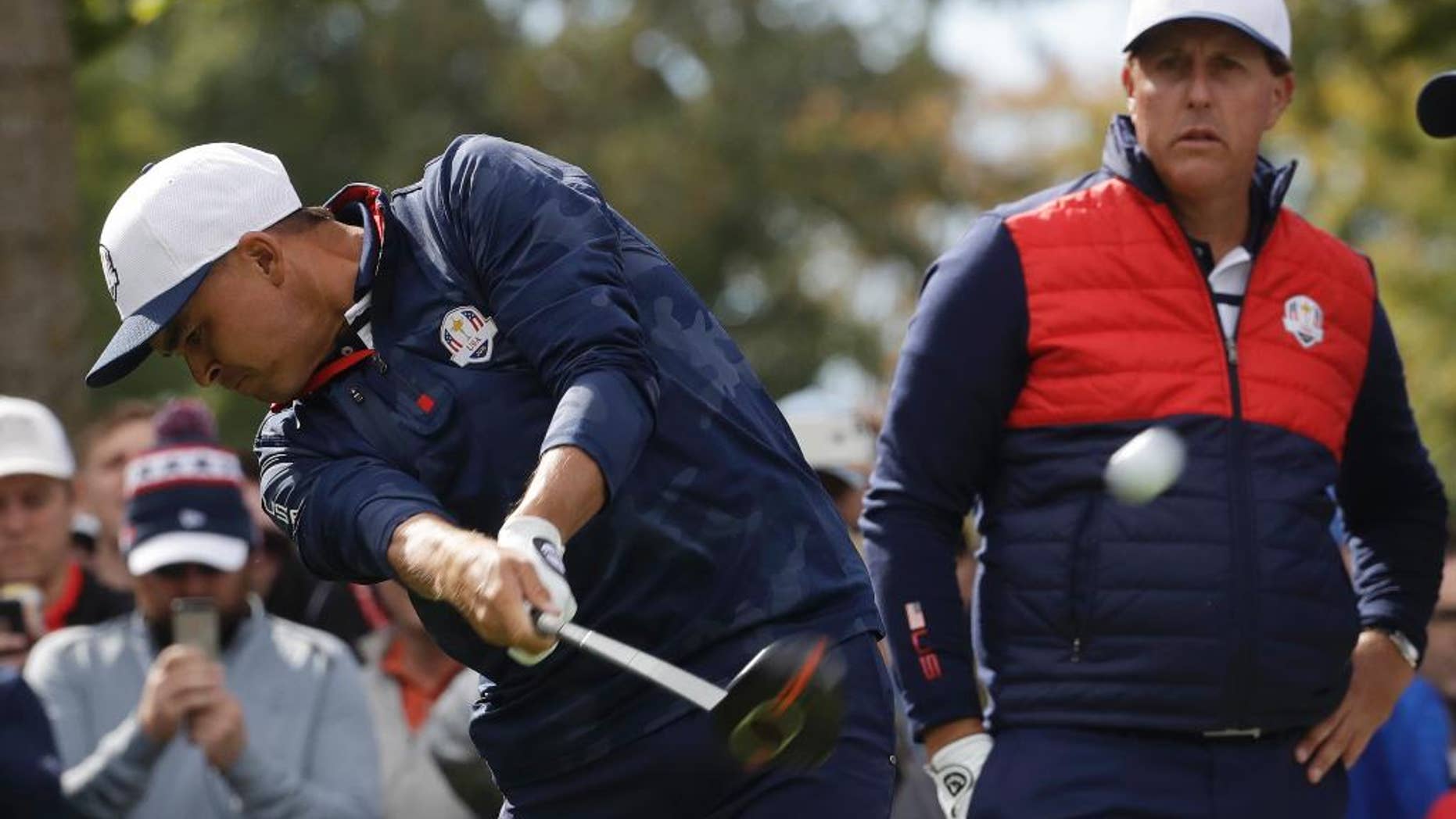 United States' Phil Mickelson watches as United States' Rickie Fowler drives on the sixth hole during a practice round for the Ryder Cup golf tournament Tuesday, Sept. 27, 2016, at Hazeltine National Golf Club in Chaska, Minn. (AP Photo/Chris Carlson)