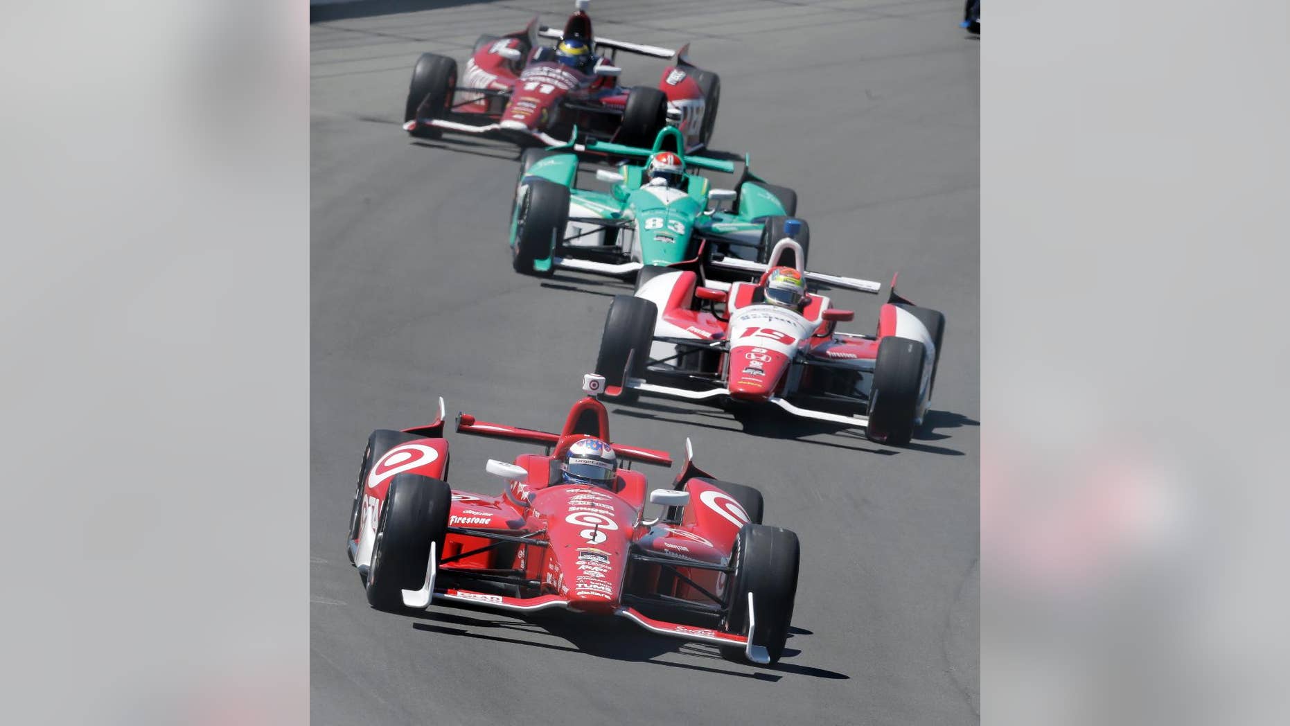 Scott Dixon (9), of Australia, leads Justin Wilson (19), of England, Charlie Kimball (83), and Sebastien Bourdais, of France (11), into turn one during the Pocono IndyCar 500 auto race, Sunday, July 6, 2014, in Long Pond, Pa. (AP Photo/Mel Evans)