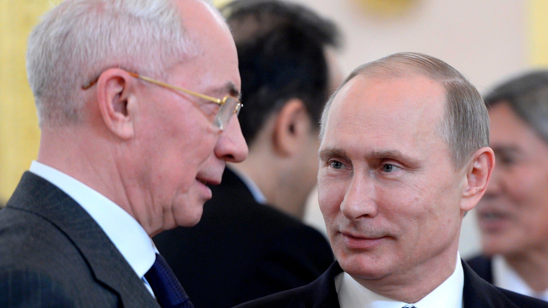 Russian President Vladimir Putin, right, and Ukrainian Prime Minister Mykola Azarov speak before a meeting of the Eurasian Economic Community in the Kremlin in Moscow, Tuesday, Dec. 24, 2013. (AP Photo/RIA-Novosti, Alexei Nikolsky, Presidential Press Service)