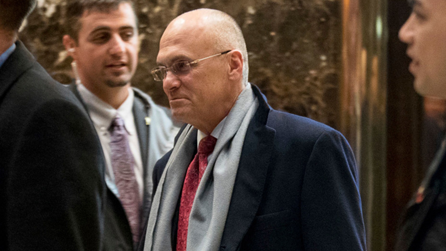Dec. 7, 2016: CKE Restaurants CEO Andrew Puzder, center, departs Trump Tower in New York.