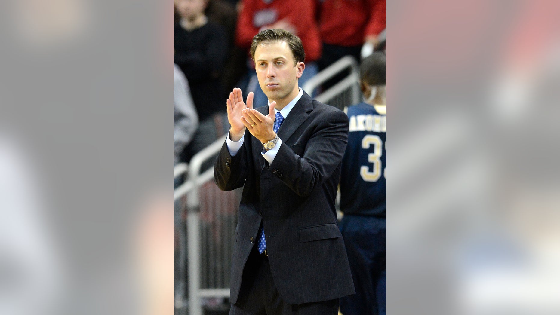 FILE - In this Dec. 19, 2012 file photo, Florida International coach Richard Pitino applauds his team's effort during the second half of an NCAA college basketball game against Louisville in Louisville, Ky. Minnesota is in advanced discussions with Richard Pitino, the son of Louisville coach Rick Pitino, to take over for Tubby Smith. Two people with knowledge of the discussions say Pitino engaged in negotiations with Minnesota officials on Wednesday, April 3, 2013. The people requested anonymity because the deal has not been formally completed. In his lone season at Florida International, Pitino led the Panthers to an 18-14 record, the school's first winning season in 13 years. (AP Photo/Timothy D. Easley, File)