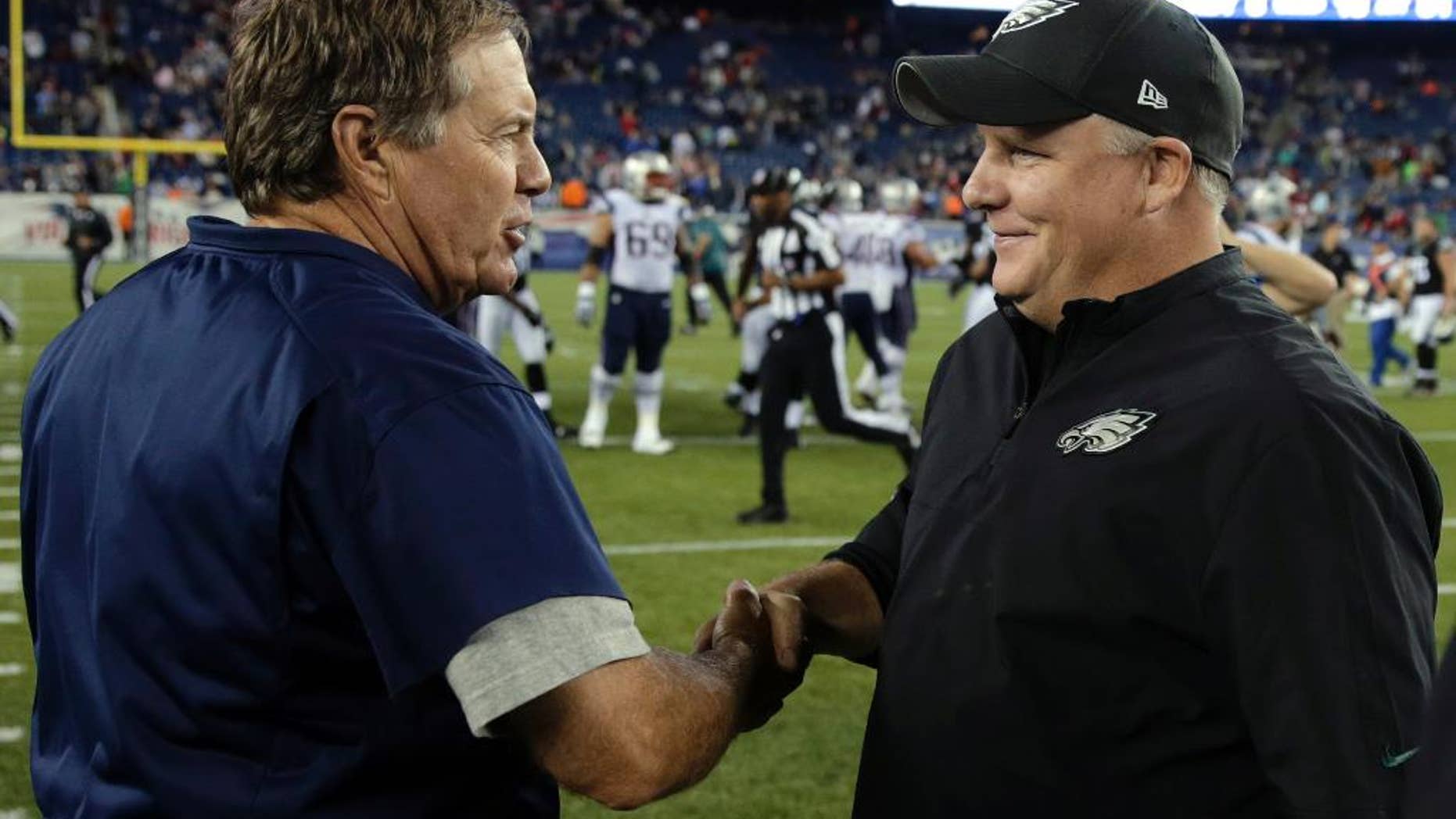 New England Patriots coach Bill Belichick, left, shakes hands with Philadelphia Eagles coach Chip Kelly after an NFL preseason football game Friday, Aug. 15, 2014, in Foxborough, Mass. The Patriots won 42-35. (AP Photo/Charles Krupa)