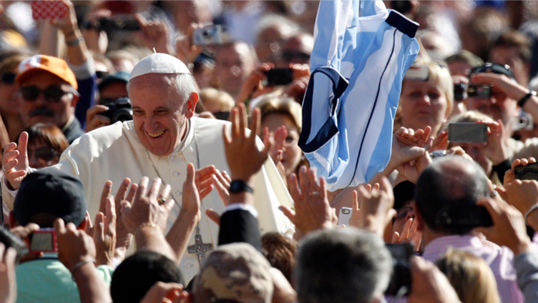 Pope Francis greets faithful upon arrival for his weekly general audience in St. Peter's Square at the Vatican, Wednesday, Sept. 18, 2013.