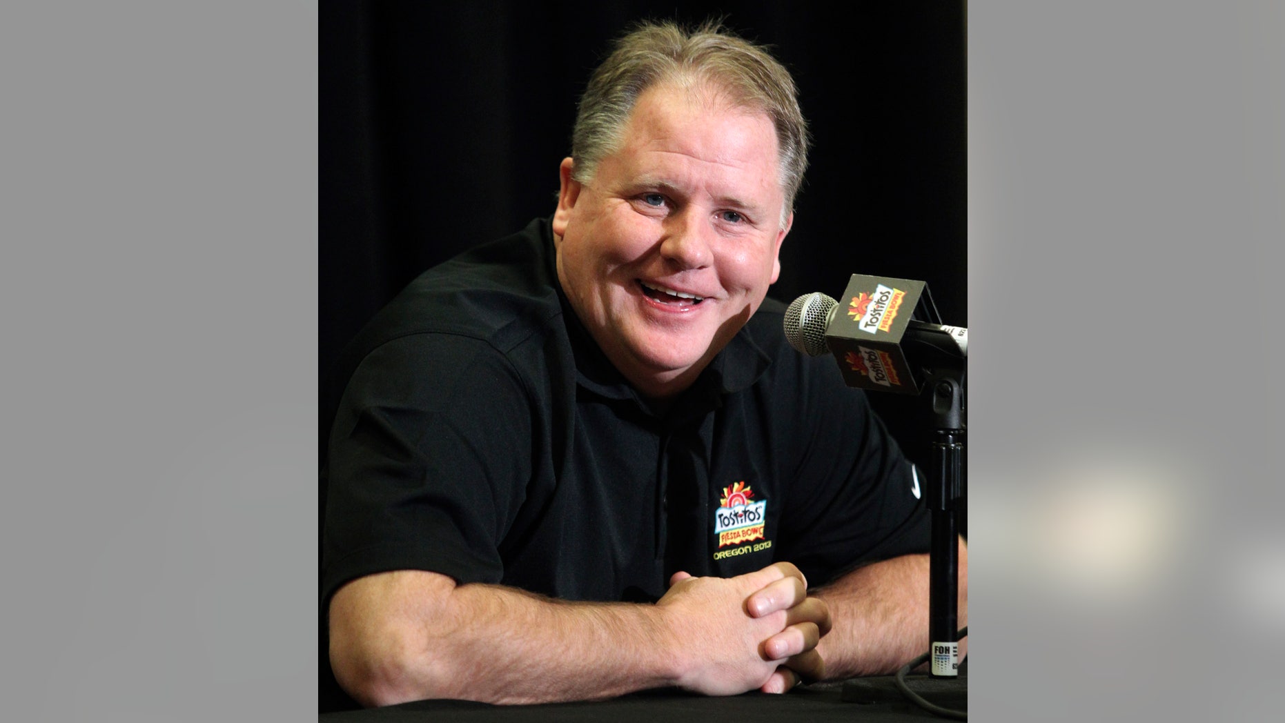 Oregon head coach Chip Kelly laughs as he answers a reporter's question during media day for the Fiesta Bowl NCAA college football game, Monday, Dec. 31, 2012, in Scottsdale, Ariz. Oregon is scheduled to play Kansas State on Jan. 3, 2013, in Glendale. (AP Photo/Paul Connors)