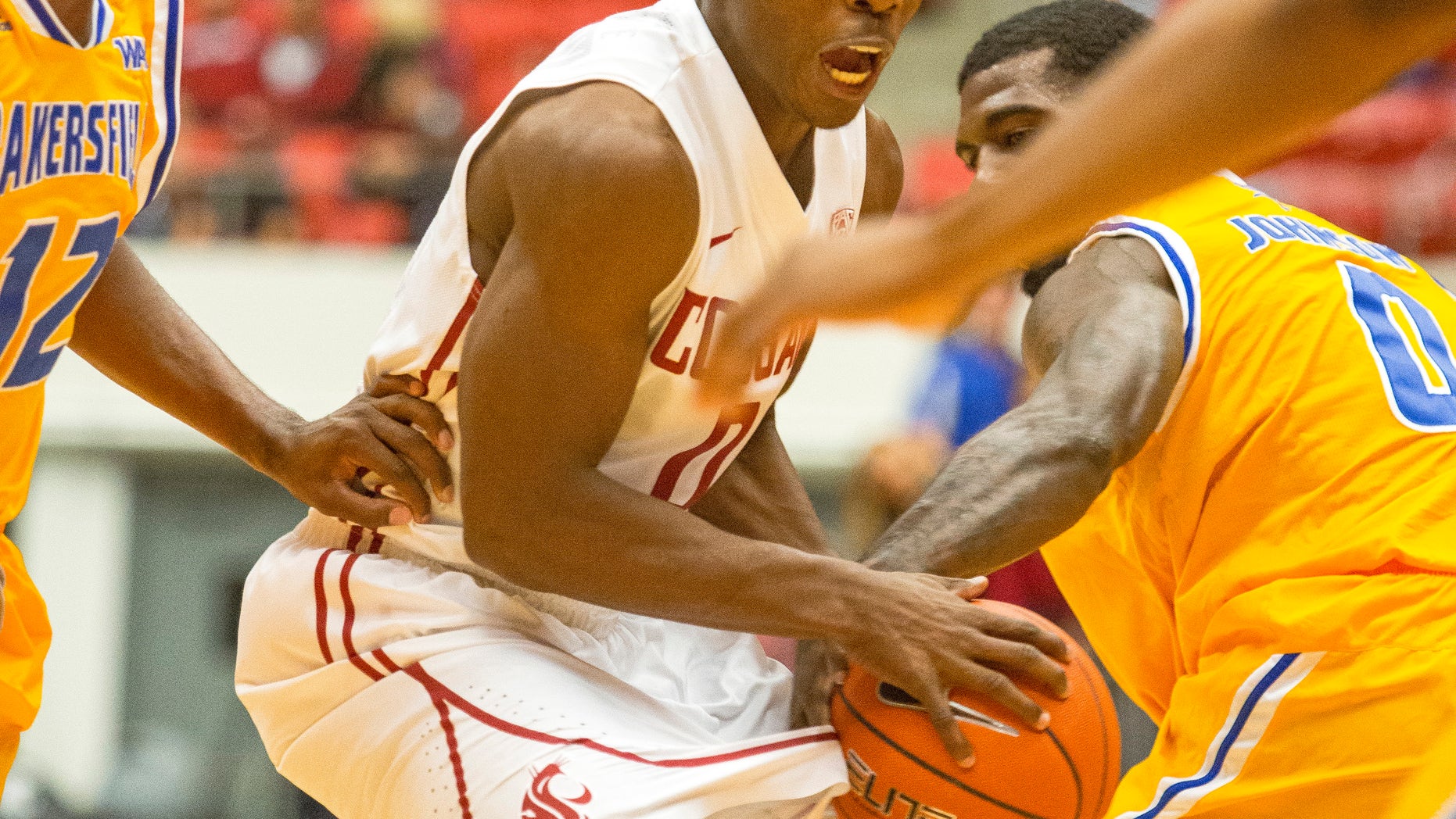 Cal State Bakersfield forward Stephon Johnson (0) strips the ball from Washington State guard Ike Iroegbu, center, as guard Issiah Grayson, left, watches during the first half of an NCAA college basketball game on Friday, Nov. 8, 2013, at Beasley Coliseum in Pullman, Wash. (AP Photo/Moscow-Pullman Daily News, Dean Hare)