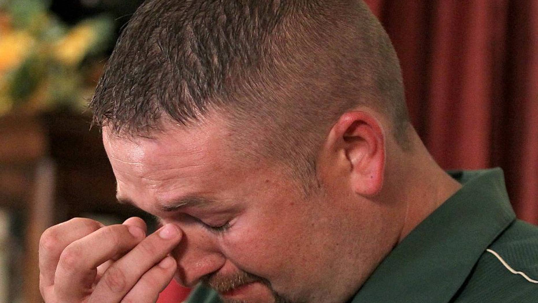 FILE - In this June 15, 2015 file photo, Matthew Clendennen wipes away tears in Hewitt, Texas. as he address the media about the Twin Peaks biker shootout and how its affected his life. A Texas appeals court on Friday, Aug. 7, 2015 reversed a gag order in a criminal case arising from a shootout saying the Waco court had abused its discretion in the case of Clendennen, the only arrested biker who has filed a lawsuit against local authorities alleging that he was arrested without probable cause. (Jerry Larson/Waco Tribune Herald via AP, File)