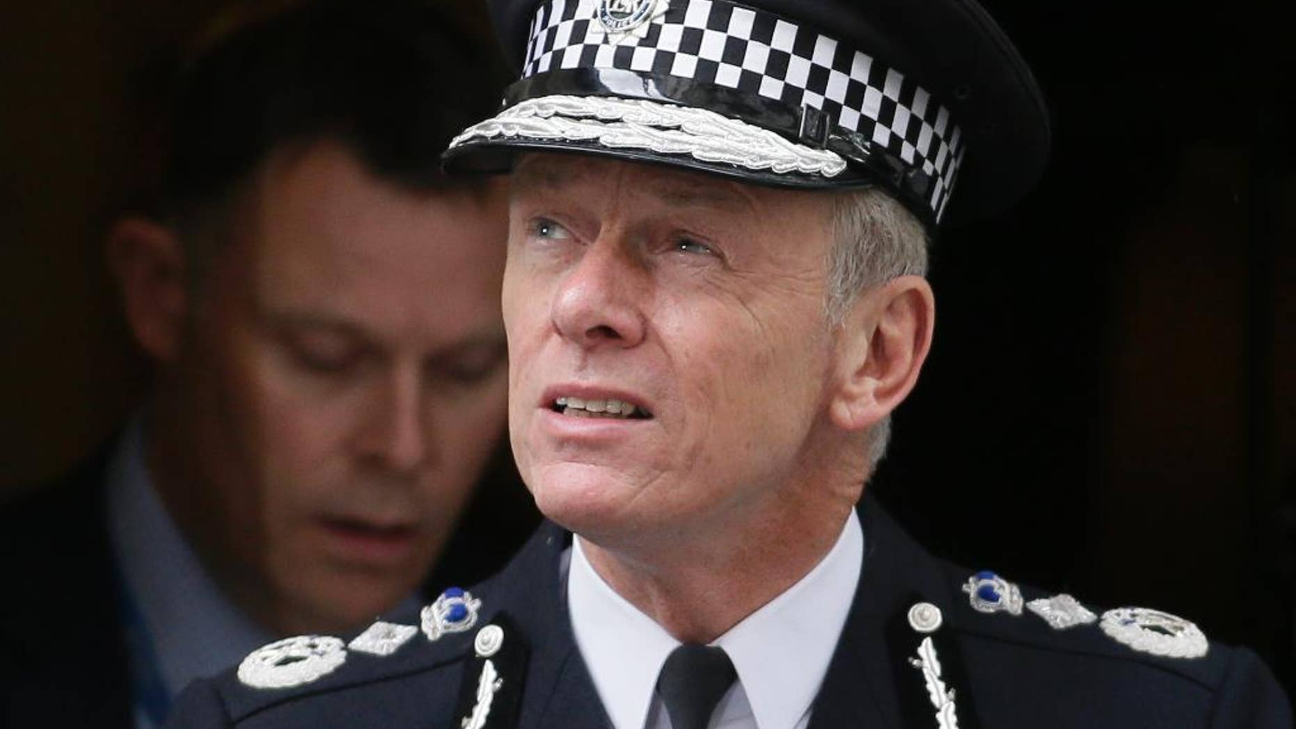FILE - In this Thursday, May 23, 2013 file photo, the Commissioner of the London Metropolitan Police Bernard Hogan-Howe leaves 10 Downing Street in London. British police on Monday, March 16, 2015, arrested an 18-year-old suspected of planning to travel to join Islamic State militants in Syria, hours after three other U.K. teens detained in Turkey were released on bail. The arrests are signs of increasingly strenuous efforts by police to stop the flow of radicalized young Britons to the Middle East. Detectives have been criticized for failing to prevent three 15- and 16-year-old London girls from making the same journey last month. Metropolitan Police Commissioner Bernard Hogan-Howe has said the girls would not be charged with terrorism offenses if they came home. (AP Photo/Alastair Grant, File)