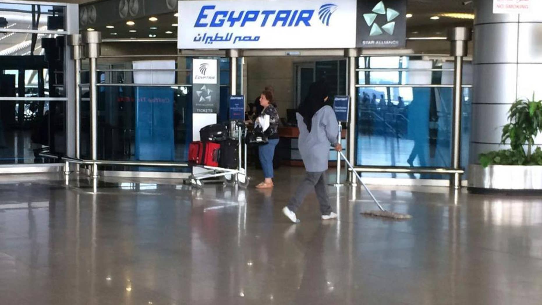 FILE - In this Thursday, May 19, 2016, file photo, the Egyptair logo is seen at the arrivals section of Cairo International Airport, Egypt. Egyptian Aviation officials said on Sunday they would soon announce a tender for a new security system for Cairo airport employees involving retina scans, attempting to meet a key Russian condition to resume flights to Egypt. (AP Photo/Amr Nabil, File)
