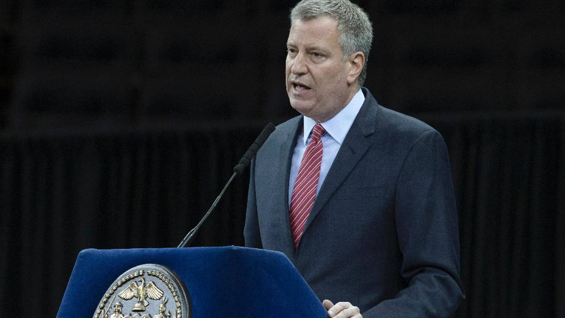 File-This Dec. 29, 2014, file photo shows New York City Mayor Bill de Blasio speaking during a New York Police Academy graduation ceremony at Madison Square Garden in New York. In the aftermath of last month’s terror attacks in Paris, New York City not only bolstered security but quietly stepped up outreach efforts to its Muslim community. It aimed to calm fears about any hate-filled retaliation while trying to extend government services to a community that often has felt neglected. (AP Photo/John Minchillo, File)