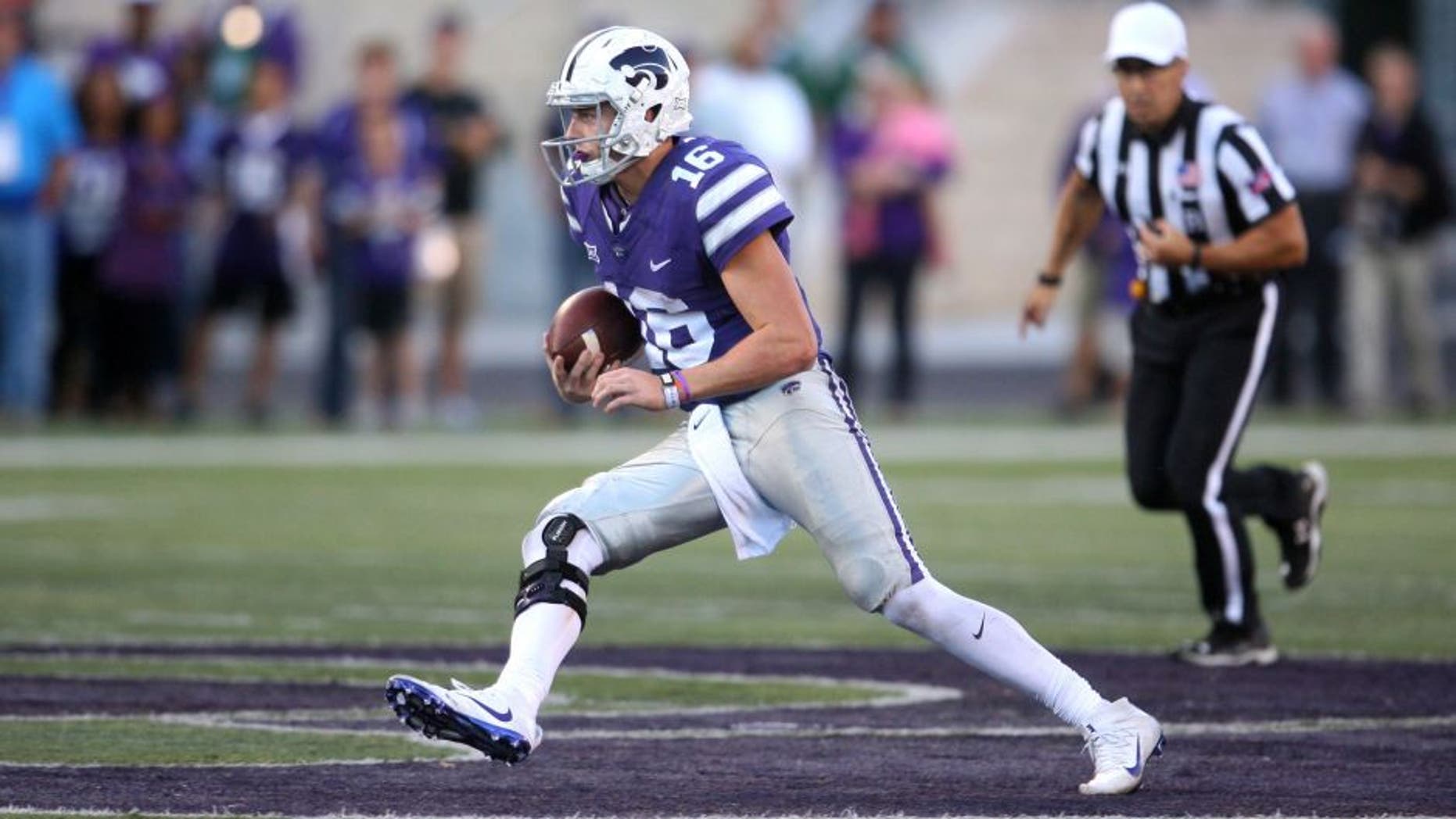 Nov 5, 2016; Manhattan, KS, USA; Kansas State Wildcats quarterback Jesse Ertz (16) finds room to run against the Oklahoma State Cowboys at Bill Snyder Family Football Stadium. The Cowboys won 43-37. Mandatory Credit: Scott Sewell-USA TODAY Sports