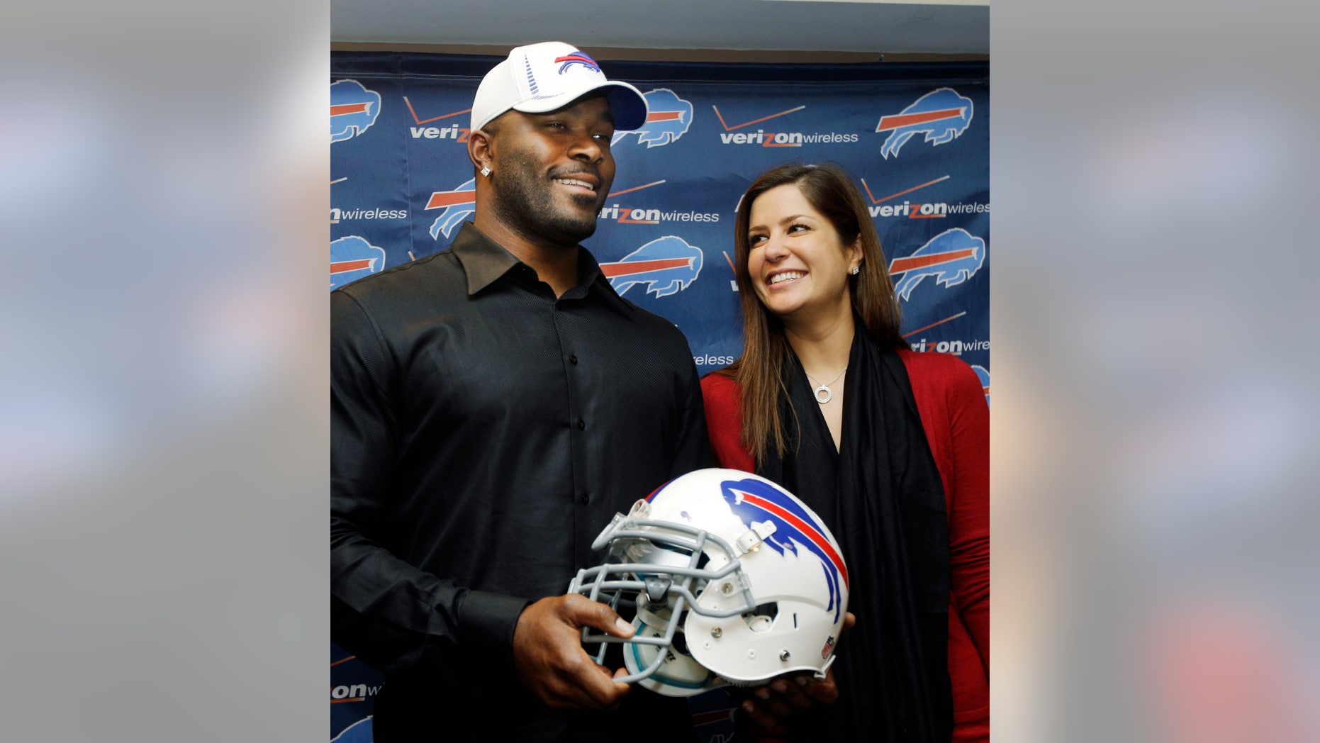 FILE - In this March 15, 2012 photo, Buffalo Bills' Mario Williams poses for a photo with his fiancee Erin Marzouki smile after an NFL football news conference in Orchard Park, N.Y. Here's one thing that can happen when love goes bad: Bills defensive end Mario Williams is suing his ex-fiancee, demanding she return a $785,000 diamond engagement ring. In response, Marzouki has filed a countersuit, calling Williams' demands "ridiculous." (AP Photo/David Duprey, File)