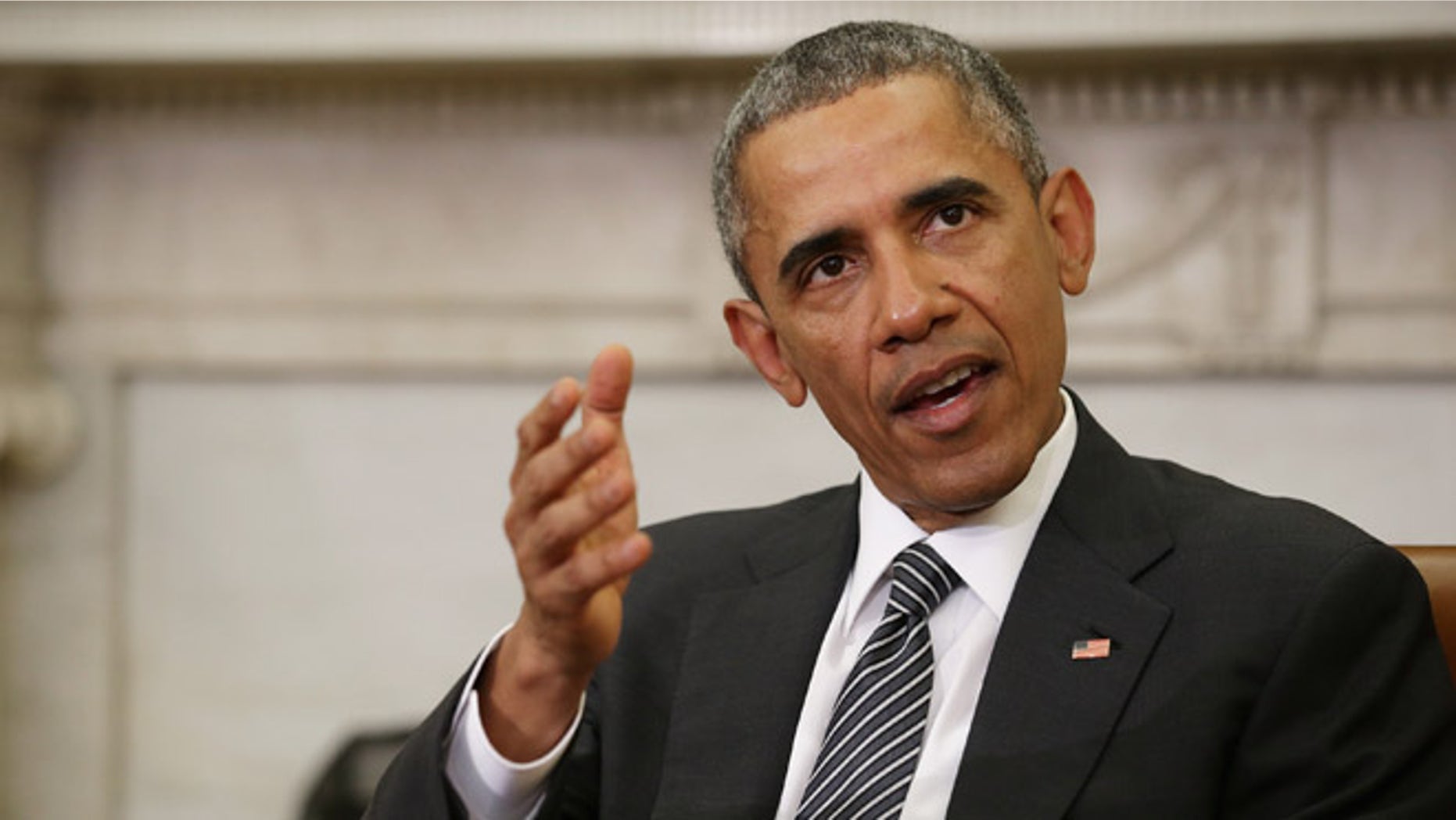 WASHINGTON, DC - FEBRUARY 17: U.S. President Barack Obama (C) talks to reporters at the end of a meeting with newly sworn-in Defense Secretary Ashton Carter in the Oval Office at the White House February 17, 2015 in Washington, DC. Obama said he rejects a federal judge's last-minute ruling that halts his executive order on immigration and said his administration will appeal. "The law is on our side and history is on our side," Obama said. (Photo by Chip Somodevilla/Getty Images)