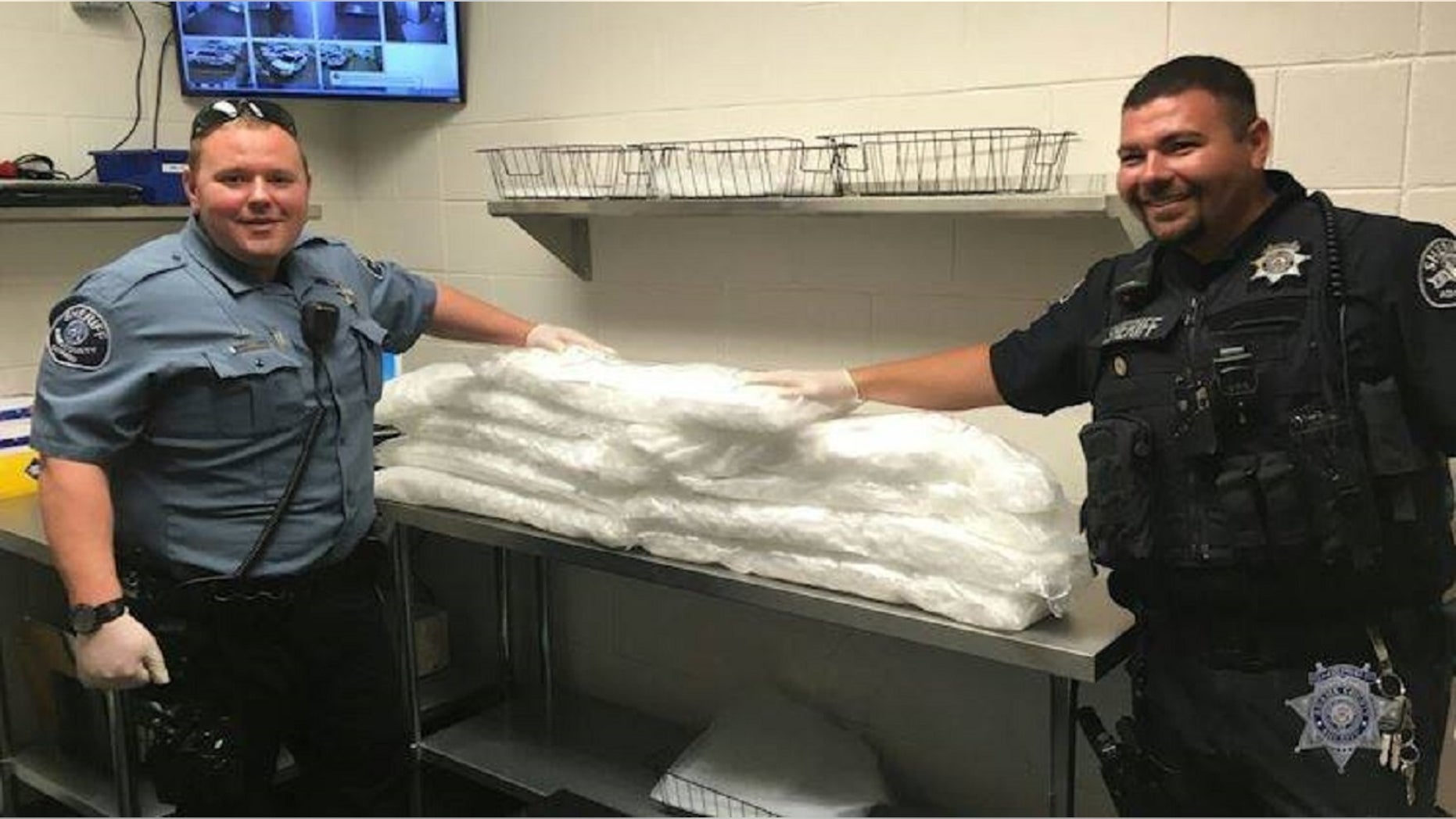 Deputies in Colorado say that more than 100 pounds of meth were discovered inside a subwoofer box over the weekend. Pictured are Deputy Joseph Bonder (left) and K-9 Deputy Eli Lopez. (right).