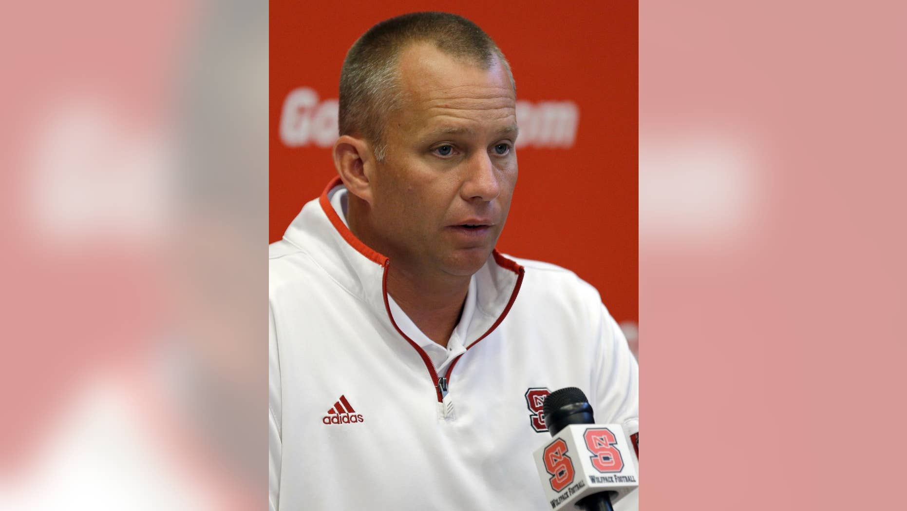 North Carolina State coach Dave Doeren speaks with reporters during an NCAA football media day in Raleigh, N.C., Sunday, Aug. 10, 2014. (AP Photo/Gerry Broome)