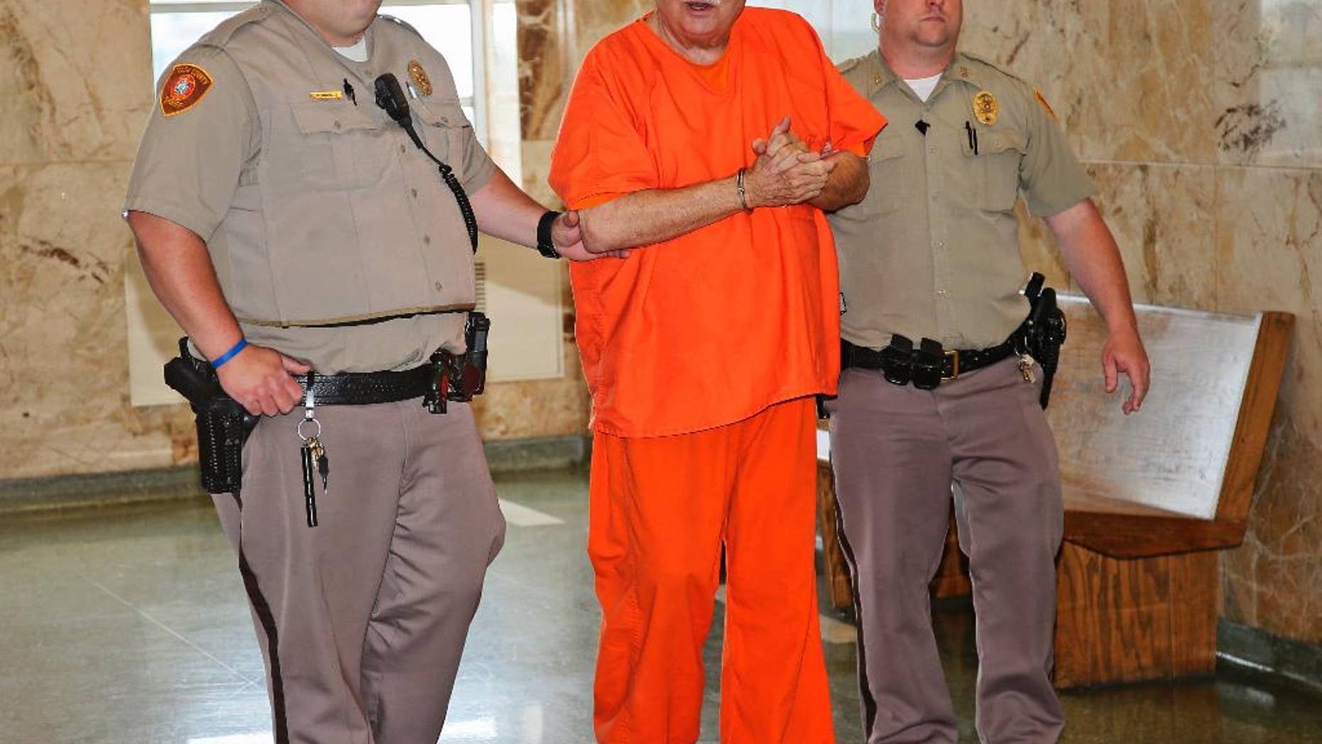 Robert Bates, a former Oklahoma volunteer sheriff's deputy who said he mistook his handgun for his stun gun when he fatally shot an unarmed suspect last year, is escorted to the courtroom for his sentencing at the courthouse in Tulsa, Okla., Tuesday, May 31, 2016. Bates was convicted of second-degree manslaughter. (AP Photo/Sue Ogrocki)