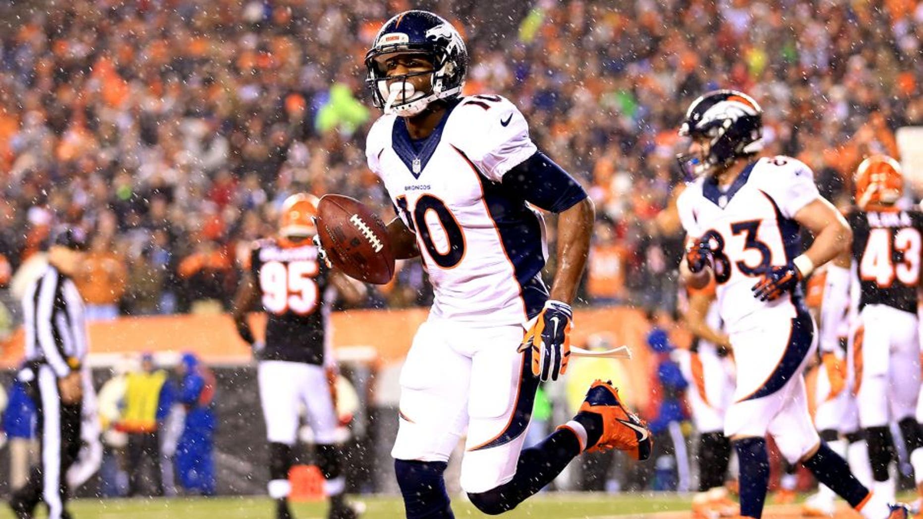 Dec 22, 2014; Cincinnati, OH, USA; Denver Broncos wide receiver Emmanuel Sanders (10) celebrates after catching a pass for a touchdown during the third quarter against the Cincinnati Bengals at Paul Brown Stadium. Mandatory Credit: Andrew Weber-USA TODAY Sports