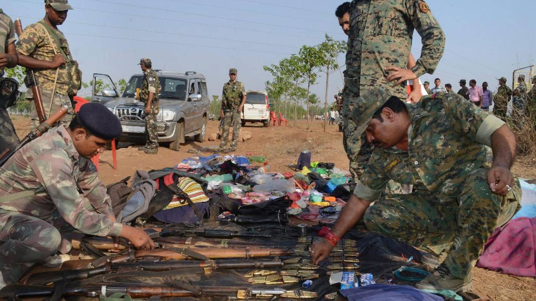 Indian policemen inspect arms and ammunition recovered from Maoist rebels after an encounter in Palamau district in Jharkhand state, India, Tuesday, June 9, 2015. Indian police said they killed at least 12 Maoist rebels in a clash early Tuesday in one of their strongholds in eastern India.(Press Trust of India via AP) INDIA OUT