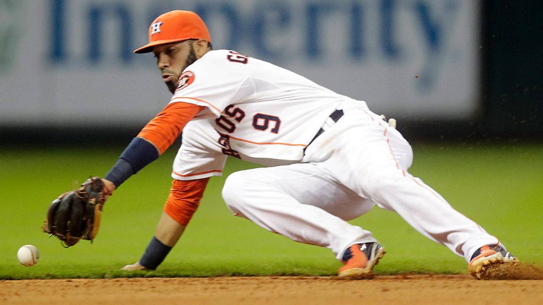 Houston Astros shortstop Marwin Gonzalez cannot catch up to a ball hit by Miami Marlins' Christian Yelich for a single during the sixth inning of a baseball game on Saturday, July 26, 2014, in Houston. (AP Photo/Patric Schneider)