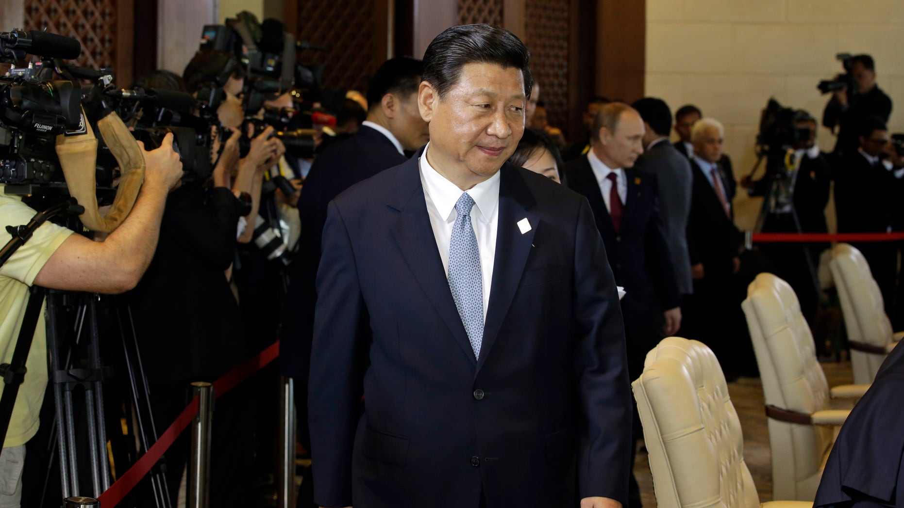 Chinese President Xi Jinping arrives to attend the Leaders Retreat during the Asia-Pacific Economic Cooperation (APEC) forum in Bali, Indonesia, Monday, Oct. 7, 2013. Pressure is mounting on Taiwan's weakened president to open political talks with Beijing after Jinping told a former senior Taiwanese official that the longstanding division between the sides should not be strung out indefinitely. China insists that the democratic island be brought under its control, and has threatened force to achieve that goal. The two sides split after a civil war in 1949. (AP Photo/Dita Alangkara)