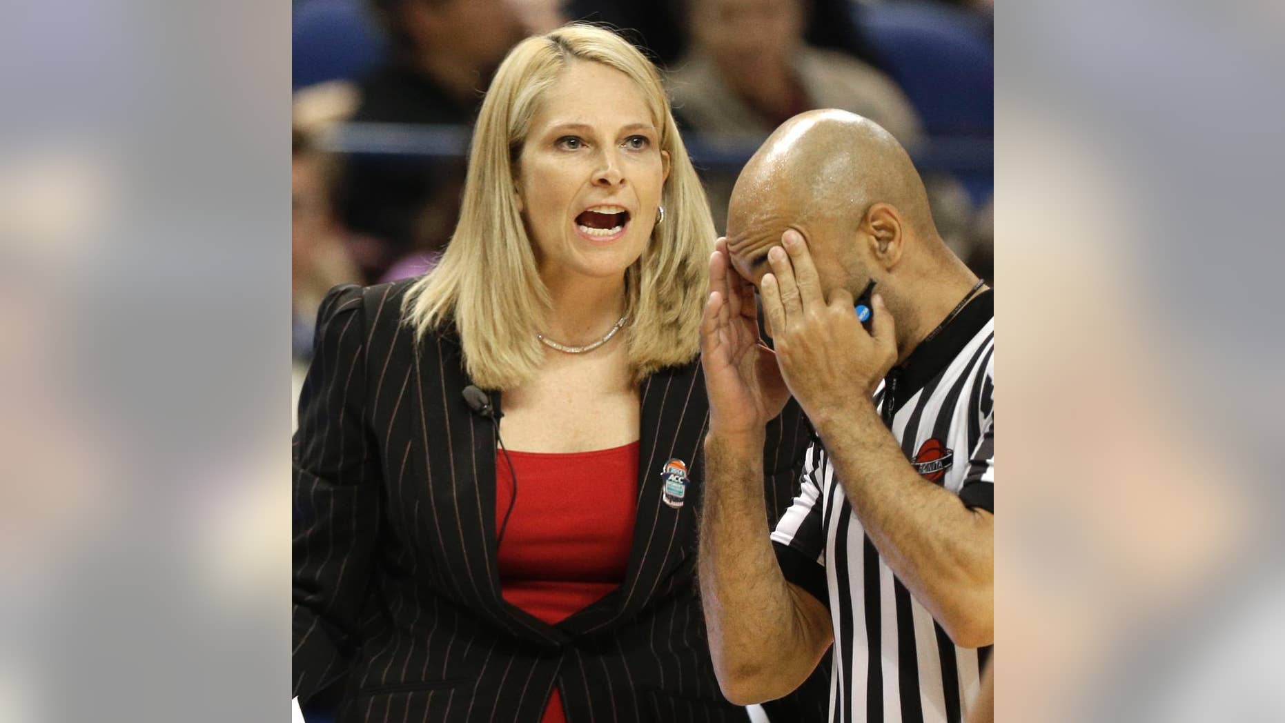 Maryland head coach Brenda Frese, left, shouts to her team as a referee walks past during the first half of an NCAA college basketball game against North Carolina at the Atlantic Coast Conference tournament in Greensboro, N.C., Friday, March 7, 2014. (AP Photo/Chuck Burton)
