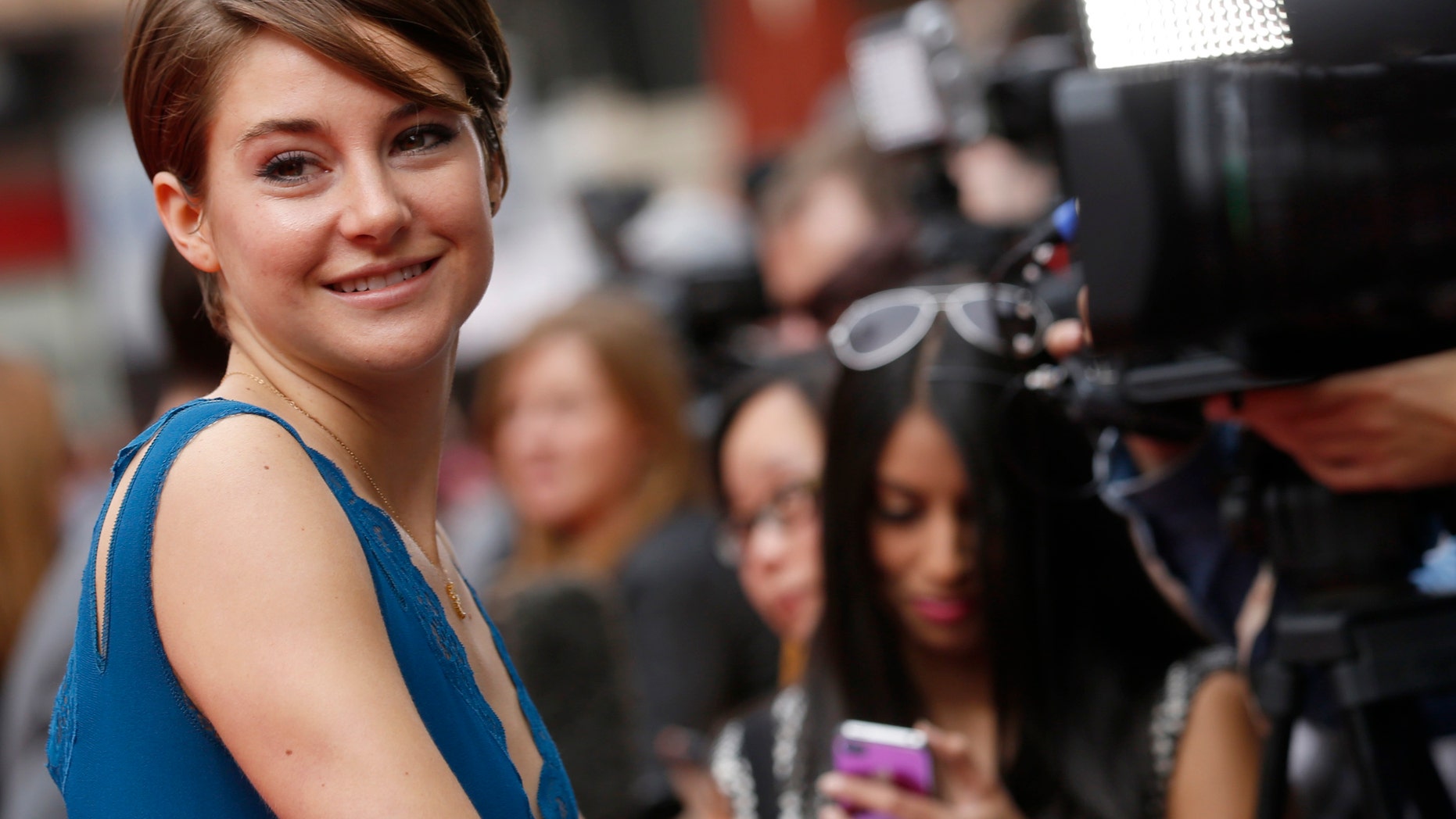 March 30, 2014. Shailene Woodley smiles as she arrives for the European premiere of "Divergent"; at Leicester Square in London.