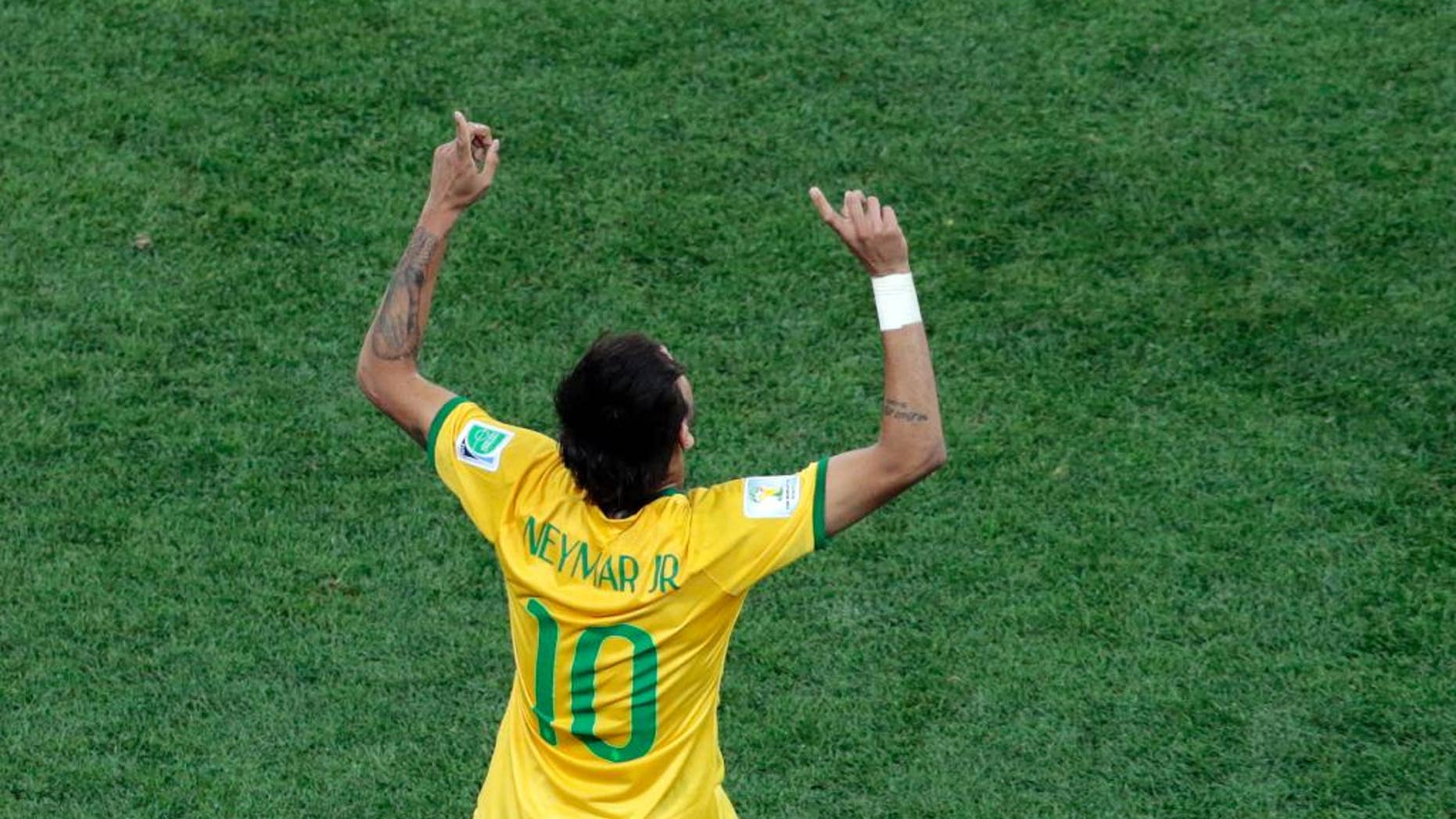 Brazil's Neymar celebrates scoring his side's first goal during the group A World Cup soccer match between Brazil and Croatia, the opening game of the tournament, in the Itaquerao Stadium in Sao Paulo, Brazil, Thursday, June 12, 2014. (AP Photo/Shuji Kajiyama)