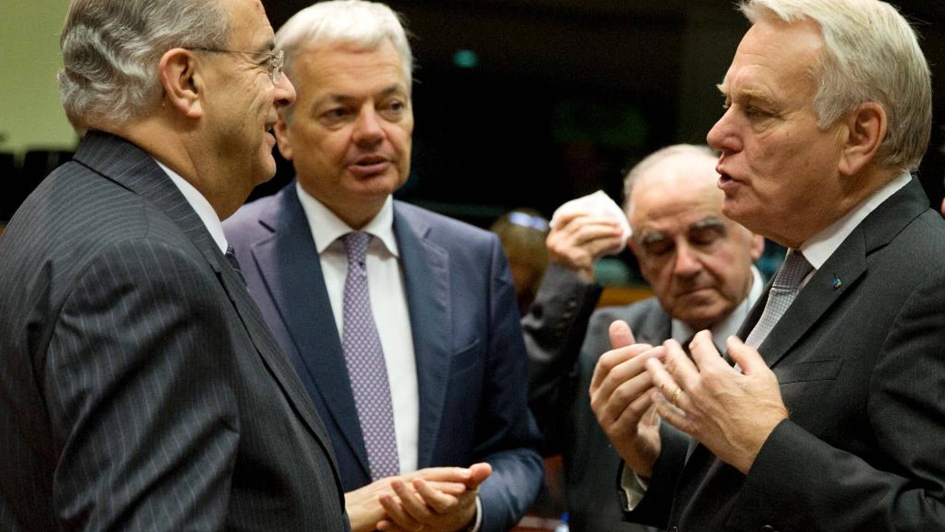 Cypriot Foreign Minister Ioannis Kasoulides, left, speaks with, from left, Belgian Foreign Minister Didier Reynders, Malta's Foreign Minister George Vella and French Foreign Minister Jean-Marc Ayrault during a round table meeting of EU foreign ministers at the EU Council building in Brussels on Monday, Dec. 12, 2016. EU foreign ministers hold talks Monday on the conflict in Syria, relations with Africa and migration. (AP Photo/Virginia Mayo)
