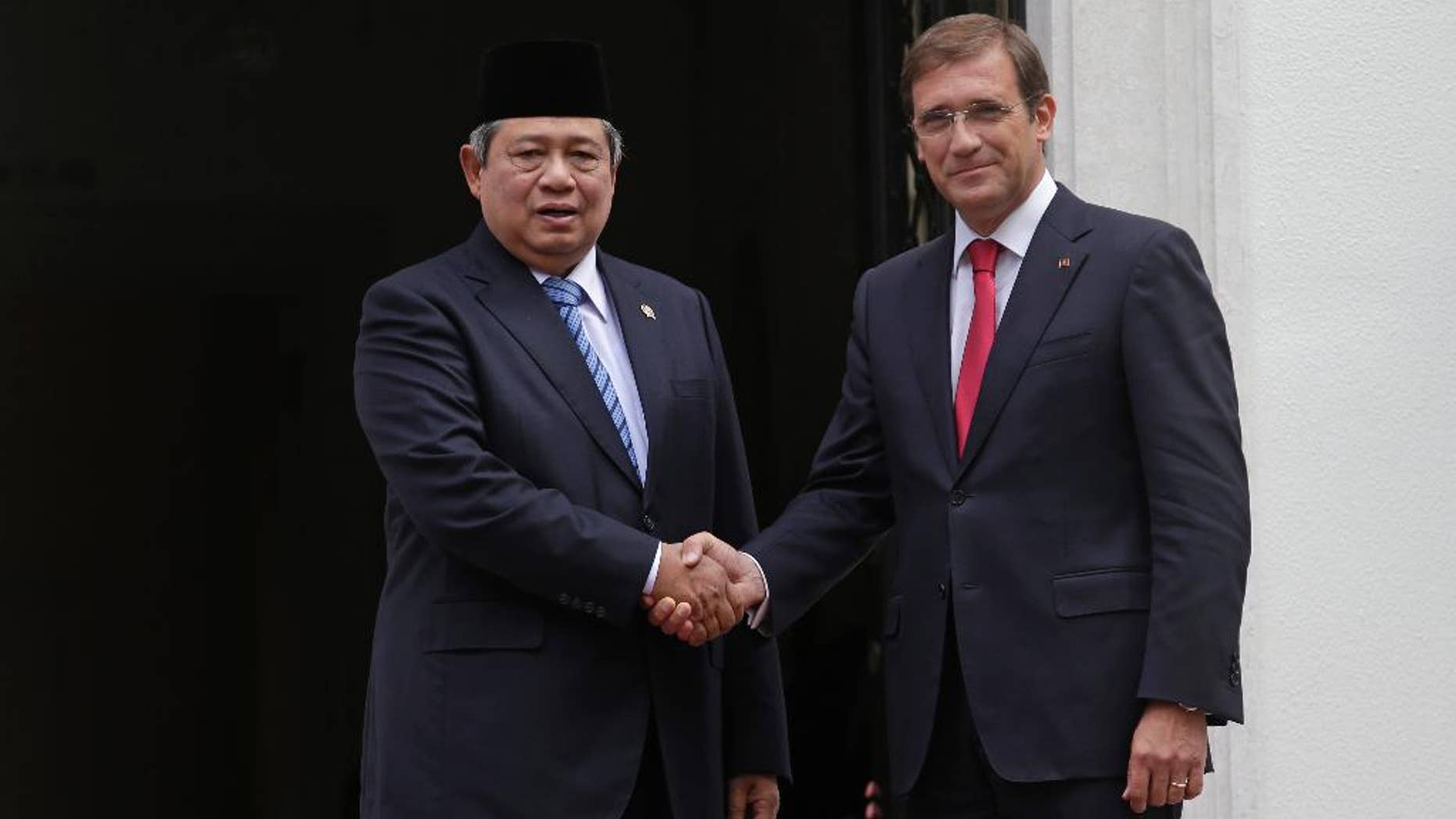 Indonesia's President Susilo Bambang Yudhoyono, left, shakes hands for the media with the Portuguese Prime Minister Pedro Passos Coelho before their meeting at the Sao Bento palace, the premier's official resident, in Lisbon, Friday, Sept. 19, 2014. The one day state visit of Yudhoyono was the first that an Indonesian President paid to Portugal since 1960. Bilateral relations between the two countries were severed during years after Indonesia annexed in 1975 East Timor, a former Portuguese colony. (AP Photo/Francisco Seco)