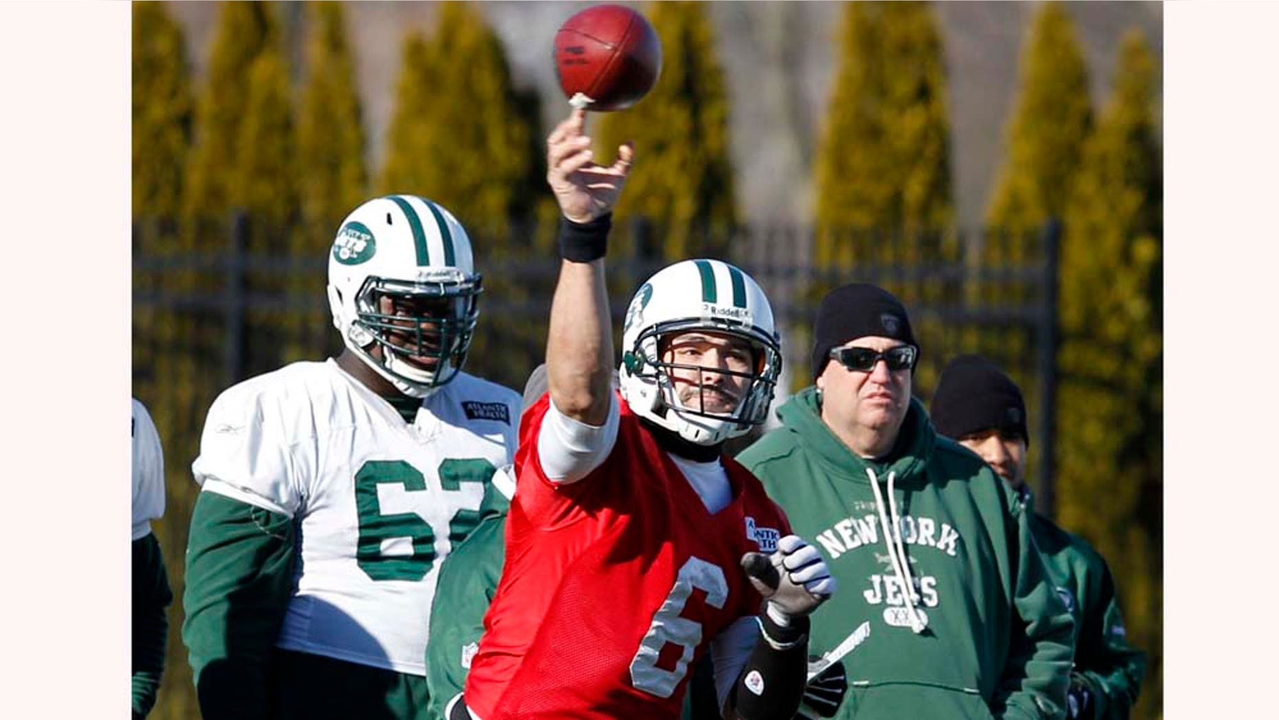 As New York Jets head coach Rex Ryan, right, and lineman Vladimir Ducasse, left, look on, quarterback Mark Sanchez throws a pass during practice Friday, Jan. 14, 2011, in Florham Park, N.J. The Jets play the New England Patriots in the AFC Divisional playoff game Sunday. (AP Photo/Mel Evans)