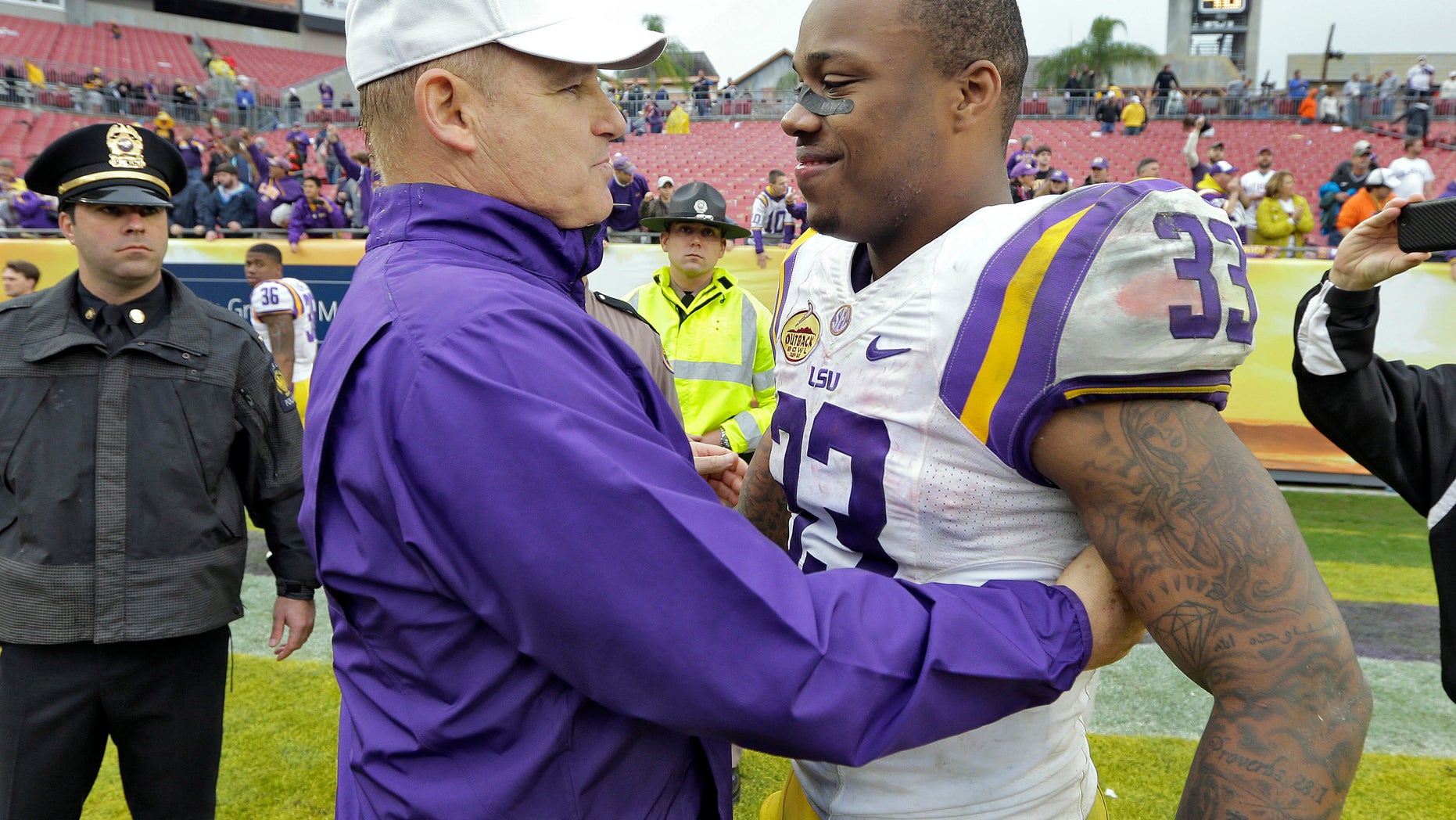 FILE - In this jan. 1, 2014 file photo, LSU head coach Les Miles, left, congratulates MVP Jeremy Hill (33) after LSU defeated Iowa 21-14 in the Outback Bowl NCAA college football game in Tampa, Fla. LSU leading rusher Jeremy Hill says he's decided to enter the NFL draft. In an announcement made Monday, jan. 13, 2014, on a social media website, Hill says he's grateful to LSU fans, friends, coaches and family and his decision was "very difficult." (AP Photo/Chris O'Meara, File)