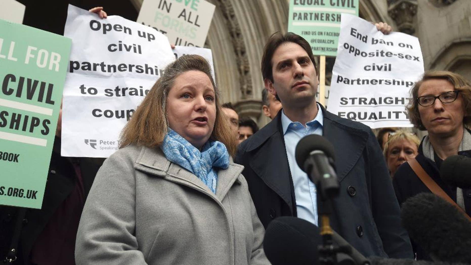 Rebecca Steinfeld, left, and Charles Keidan speak to the media outside the Royal Courts of Justice in London, Tuesday, Feb. 21, 2017. A British couple who want their relationship recognized in law without the "patriarchal baggage" of marriage have lost a bid to be allowed a civil partnership. Rebecca Steinfeld and Charles Keidan say they face discrimination because only same-sex couples are eligible for civil partnerships. The High Court ruled against them last year, and on Tuesday the Court of Appeal upheld the ruling by a 2-1 margin. (Charlotte Ball/PA via AP)