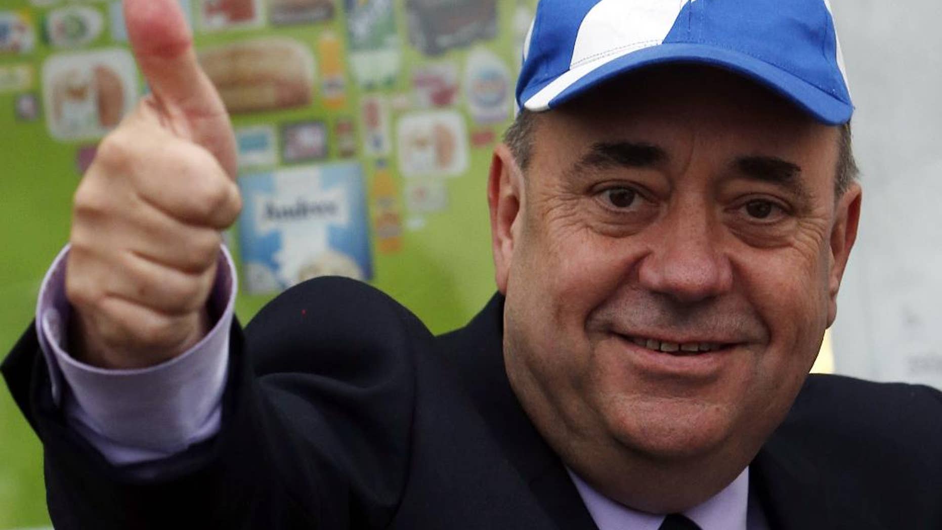 FILE - In this Thursday, Sept. 18, 2014 file photo, Scotland's First Minister Alex Salmond meets members of the public on a walkabout in Newmachar, Scotland. Scotland's former pro-independence leader, Alex Salmond, says he is going to run for a seat in the British Parliament in May's election. Salmond announced Sunday, Dec. 7, 2014 that he will contest a northeast Scotland seat for the Scottish National Party, which he led until last month. (AP Photo/Scott Heppell, File)