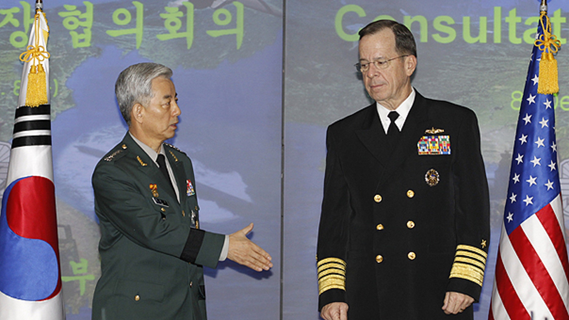 Dec. 8: Gen. Han Min-koo, chairman of South Korean Joint Chiefs of Staff, and his U.S. counterpart Adm. Mike Mullen pose for photographers before their talks at a headquarters of South Korean Defense Ministry in Seoul.