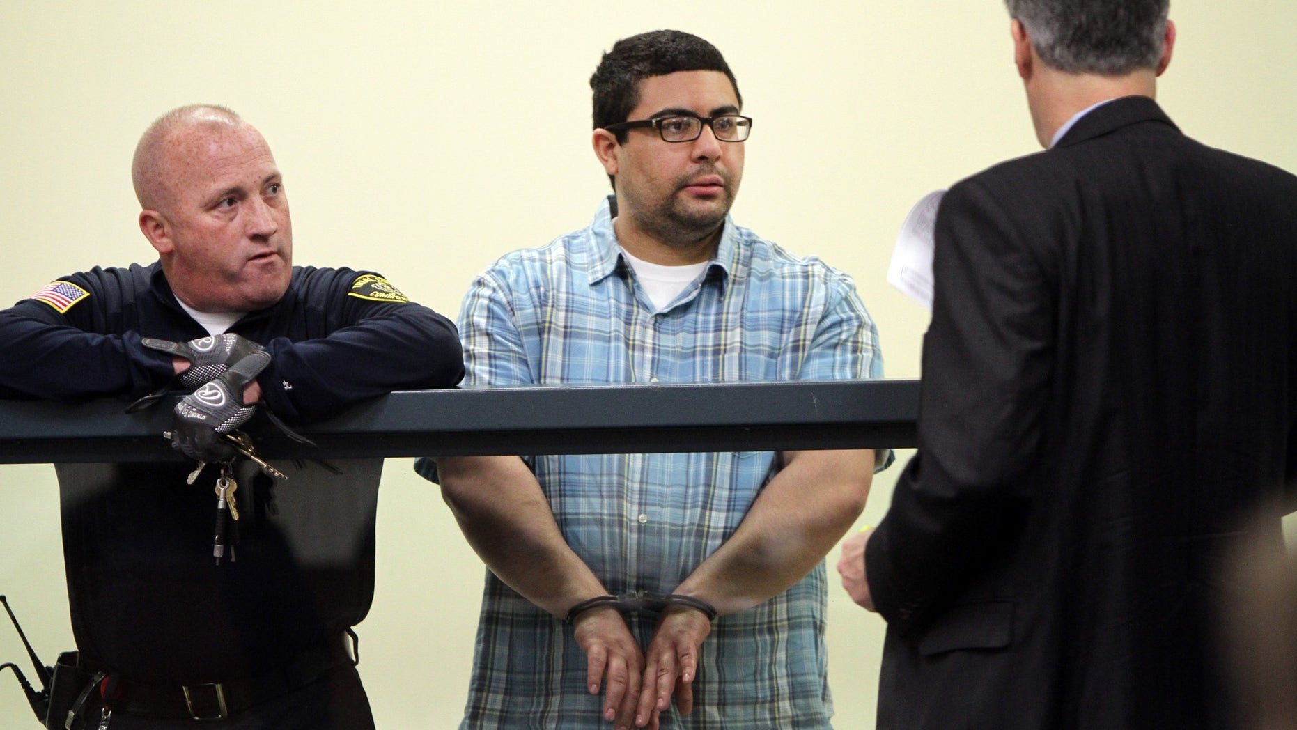 Carlos Colina, center, speaks with his attorney John Cunha, Jr., right, during his arraignment in Cambridge District Court in Medford, Mass., Monday, April 6, 2015. Colina was charged with being an accessory after the crime of assault and battery causing serious bodily injury and the improper disposal of human remains, after the discovery of human remains in Cambridge on Saturday. (AP Photo/The Boston Herald, Chitose Suzuki, Pool)