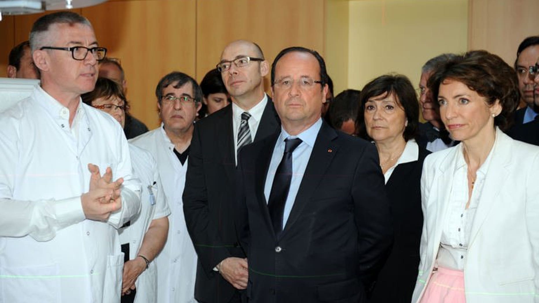 French President Francois Hollande (centre) visits the Bretagne Sud hospital in Brest, western France, on July 1, 2013. Hollande has told the United States to immediately cease spying on European institutions, after reports of covert US surveillance of EU diplomatic missions.