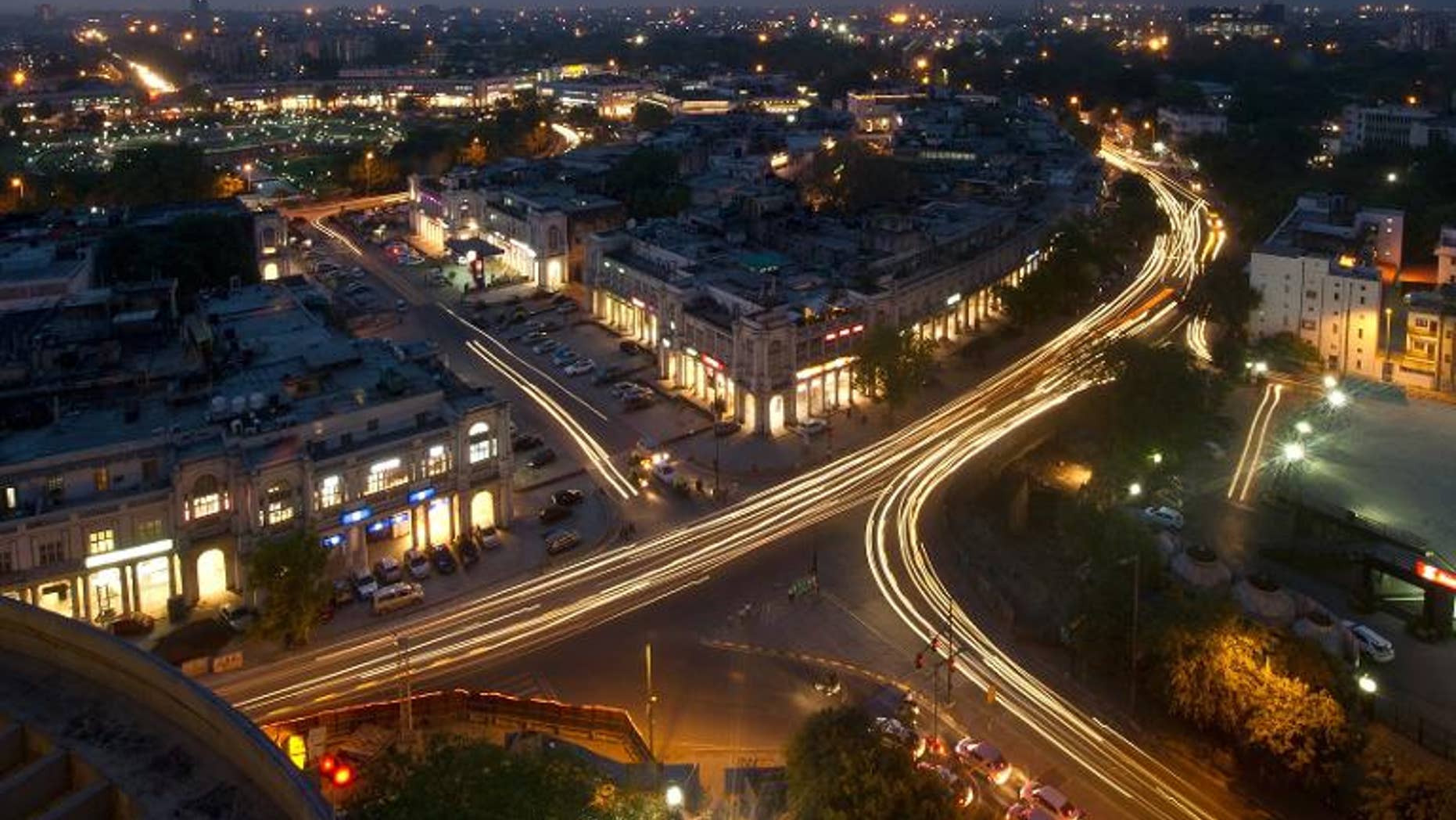 This photograph taken on April 18, 2013 shows the Indian capital's skyline as traffic drives around the outer circle of Connaught Place in the heart of New Delhi