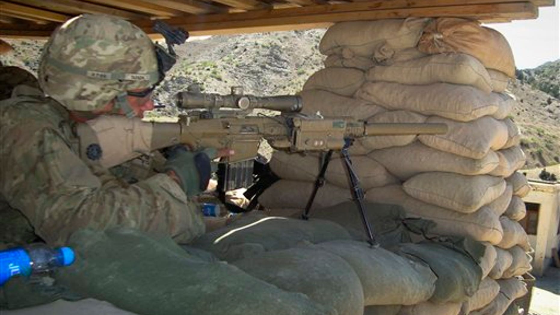 April 30: A U.S. soldier with the 1st battalion 3rd brigade and 1st infantry division monitors the area through the scope of his weapon at a check post of a joint U.S. and Afghan security forces base in Musa khel, district of Khost province southeast of Kabul, Afghanistan. (AP)