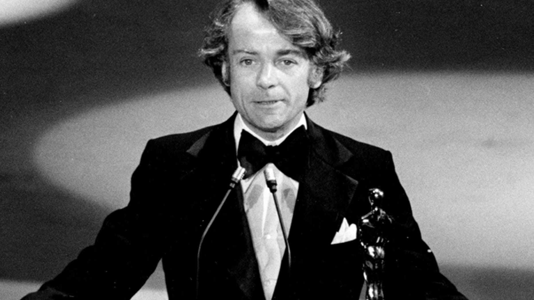 March 28, 1977, file photo, John G. Avildsen accepts the Oscar for best director for "Rocky" at the Academy Awards in Los Angeles.