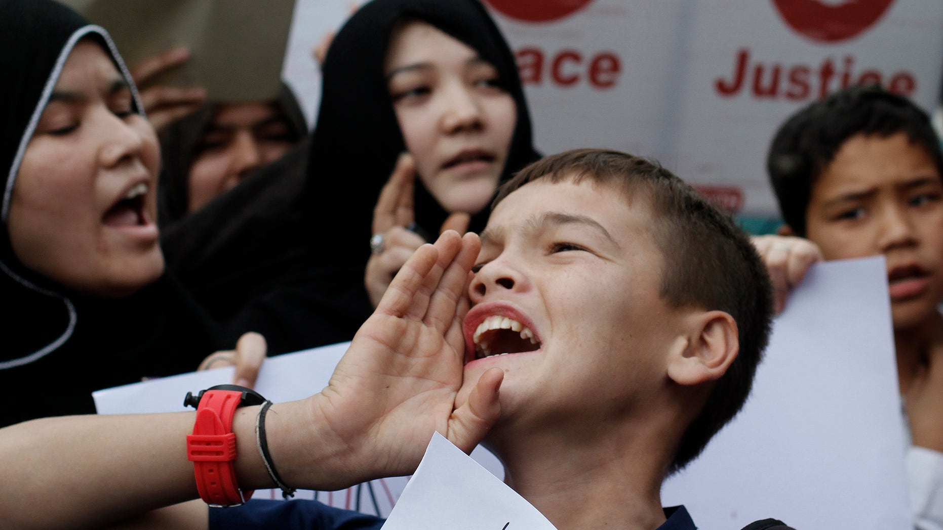 Pakistani Shiite Muslims, chant slogans during a protest to condemn Thursday's deadly bombings in Quetta, in Karachi, Pakistan, Saturday, Jan. 12, 2013. Thousands of Pakistani Shiites protested in southwestern Pakistan for a second day on Saturday, blocking a main road with dozens of coffins of relatives killed in explosions to demand better security from the government. (AP Photo/Shakil Adil)