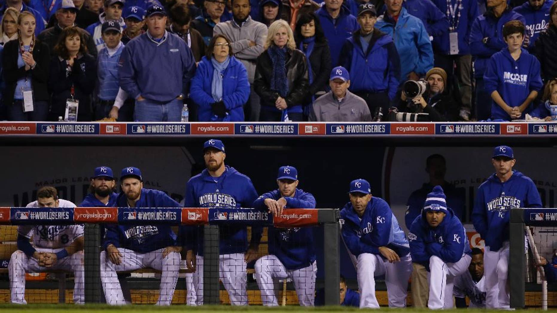 Kansas City Royals players watch from their dugout the seventh inning of Game 7 of baseball's World Series against the San Francisco Giants Wednesday, Oct. 29, 2014, in Kansas City, Mo. (AP Photo/Charlie Neibergall)