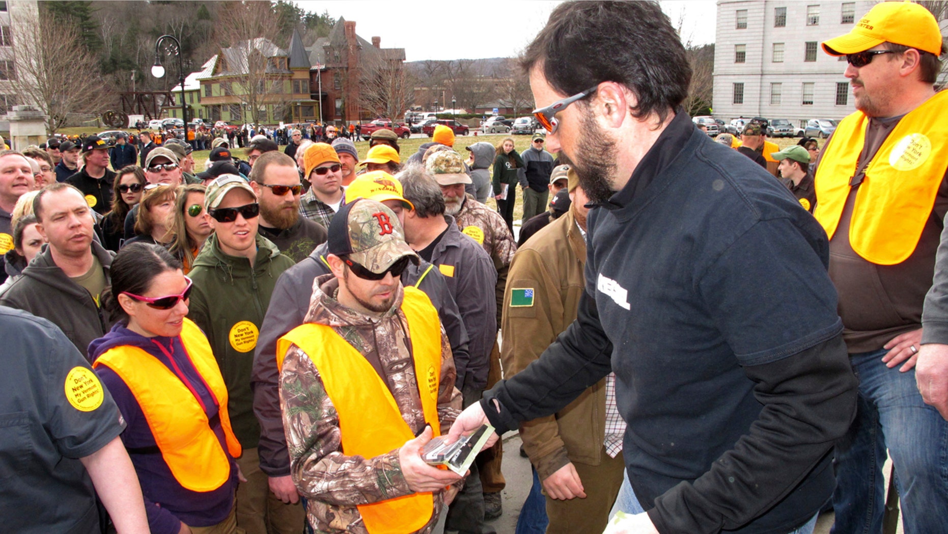 Rob Curtis, executive editor of a firearms magazine, handed out 30-round magazines at a gun rights event outside the Vermont Statehouse in Montpelier, Vt., on March 31 to oppose gun restriction legislation approved by state lawmakers.