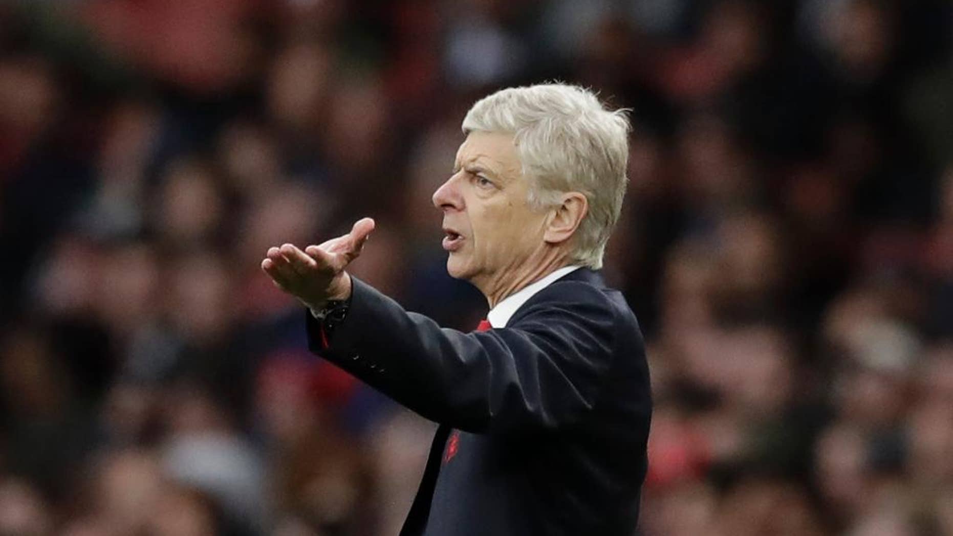 FILE - In this Saturday, Oct. 22, 2016 file photo, Arsenal's manager Arsene Wenger gestures during the English Premier League soccer match between Arsenal and Middlesbrough at the Emirates Stadium in London. The English Football Association has banned Arsenal manager Arsene Wenger from the touchline for four matches after an altercation with a match official. Wenger escaped a stadium ban for shoving fourth official Anthony Taylor in the tunnel area at Emirates Stadium on Sunday, Jan. 22, 2017 during Arsenal's 2-1 victory over Burnley in the Premier League. (AP Photo/Matt Dunham)