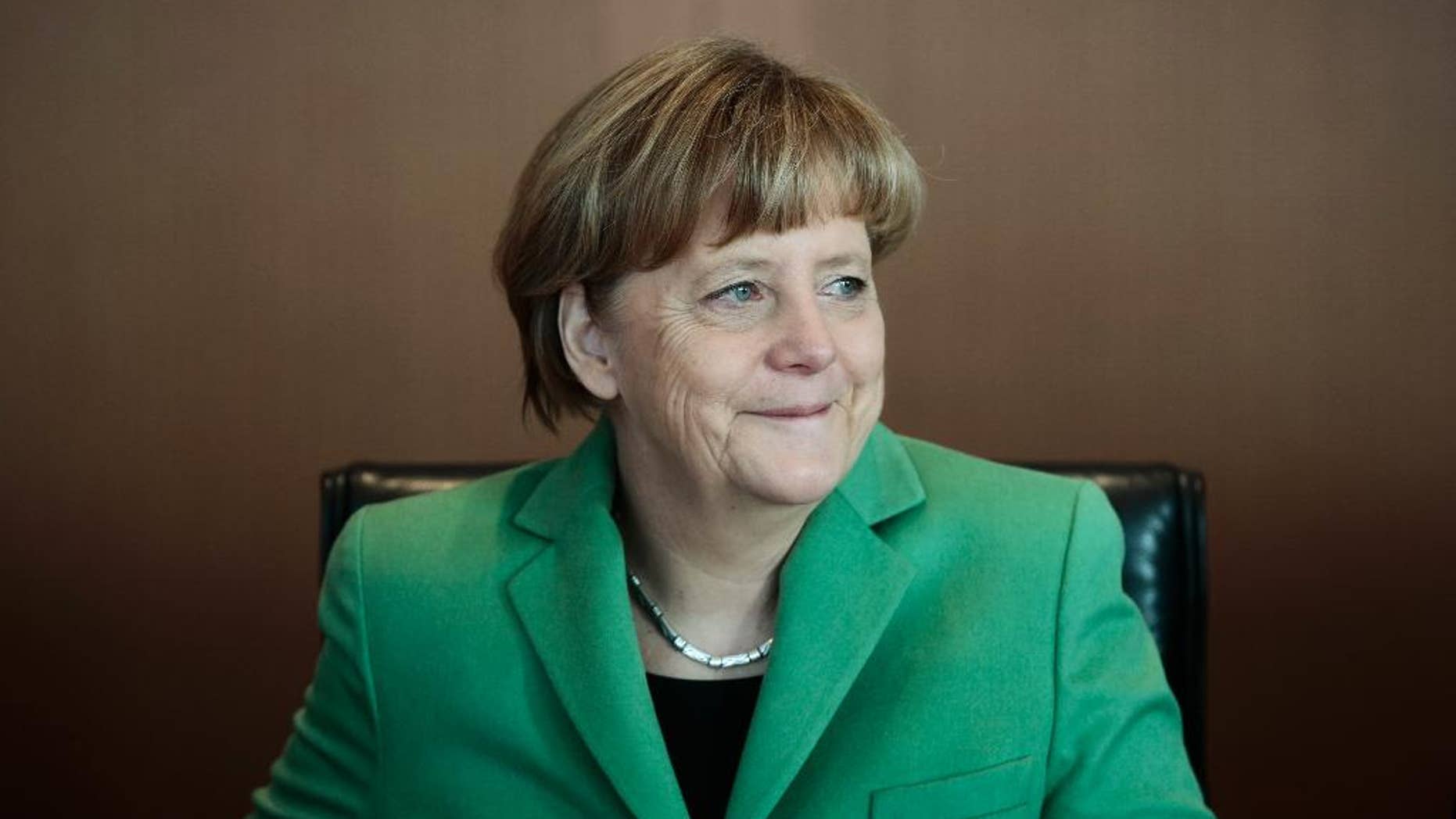 German Chancellor Angela Merkel smiles at the beginning of the weekly cabinet meeting of her government at the chancellery in Berlin, Wednesday, Jan. 28, 2015. (AP Photo/Markus Schreiber)
