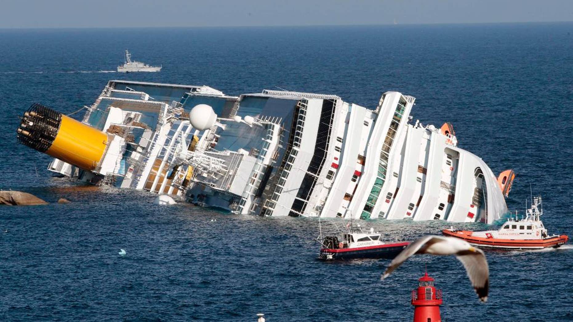 The luxury cruise ship Costa Concordia lays on its side after running aground the tiny Tuscan island of Giglio, Italy. (AP Photo/Gregorio Borgia)