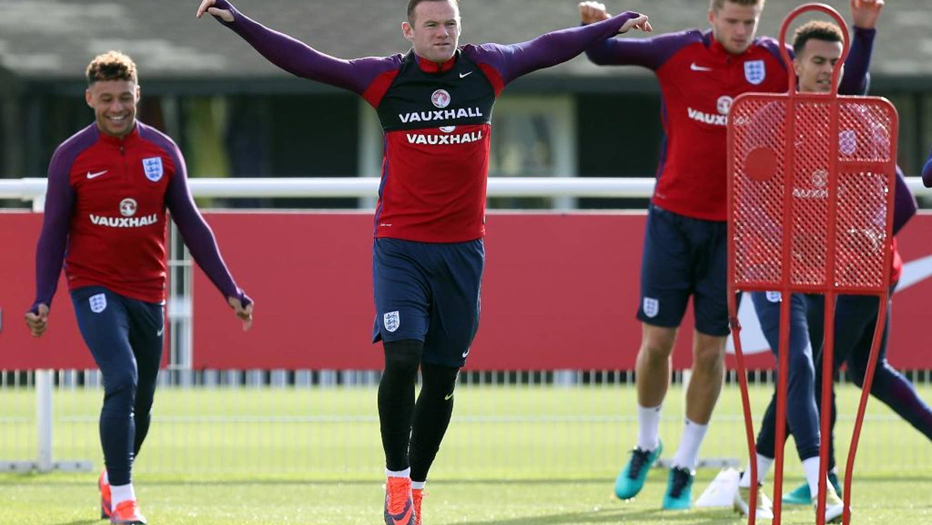 England's Wayne Rooney, center, attends a training session at Enfield Training Ground, London, Monday Oct. 10, 2016. England will play Slovenia in a World Cup qualifier on Tuesday. (Andrew Matthews/PA via AP)