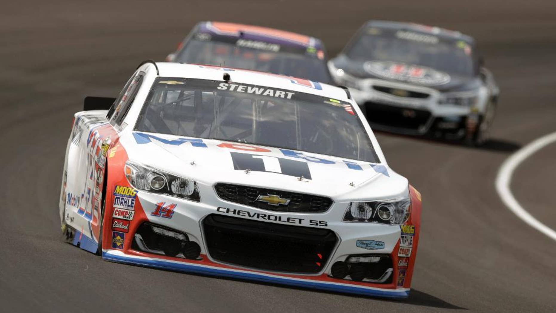 FILE - In this July 24, 2016, file photo, Tony Stewart (14) drives through the first turn during the Brickyard 400 NASCAR auto race at Indianapolis Motor Speedway in Indianapolis. Stewart will get a throwback paint scheme for the Southern 500, his final race at Darlington. (AP Photo/Michael Conroy, File)